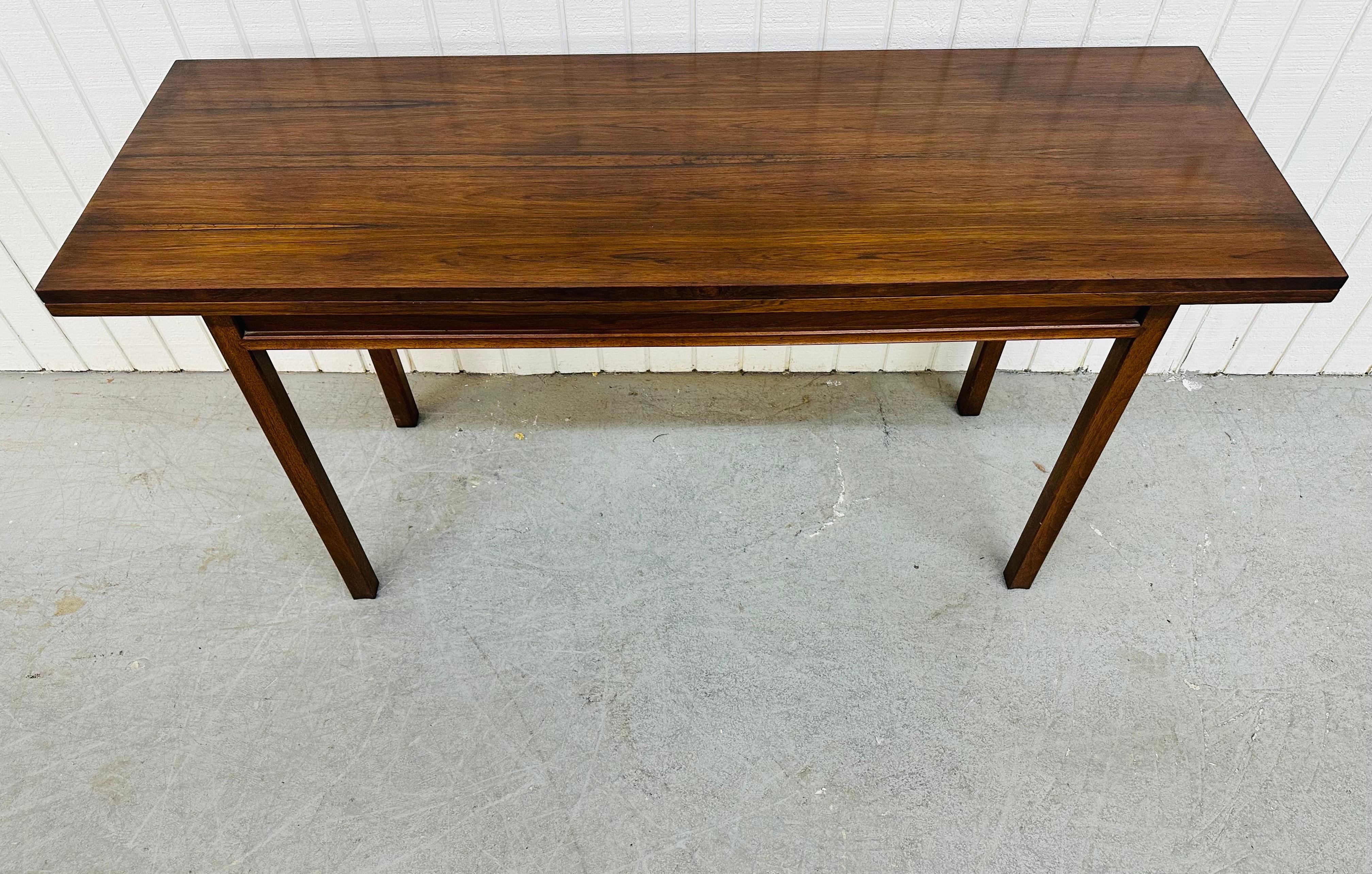 This listing is for a Mid-Century Modern John Stuart Rosewood Game Table. Featuring a straight line design, four legs, a flip top that turns the piece into a game table, and a beautiful walnut finish. This is an exceptional combination of quality