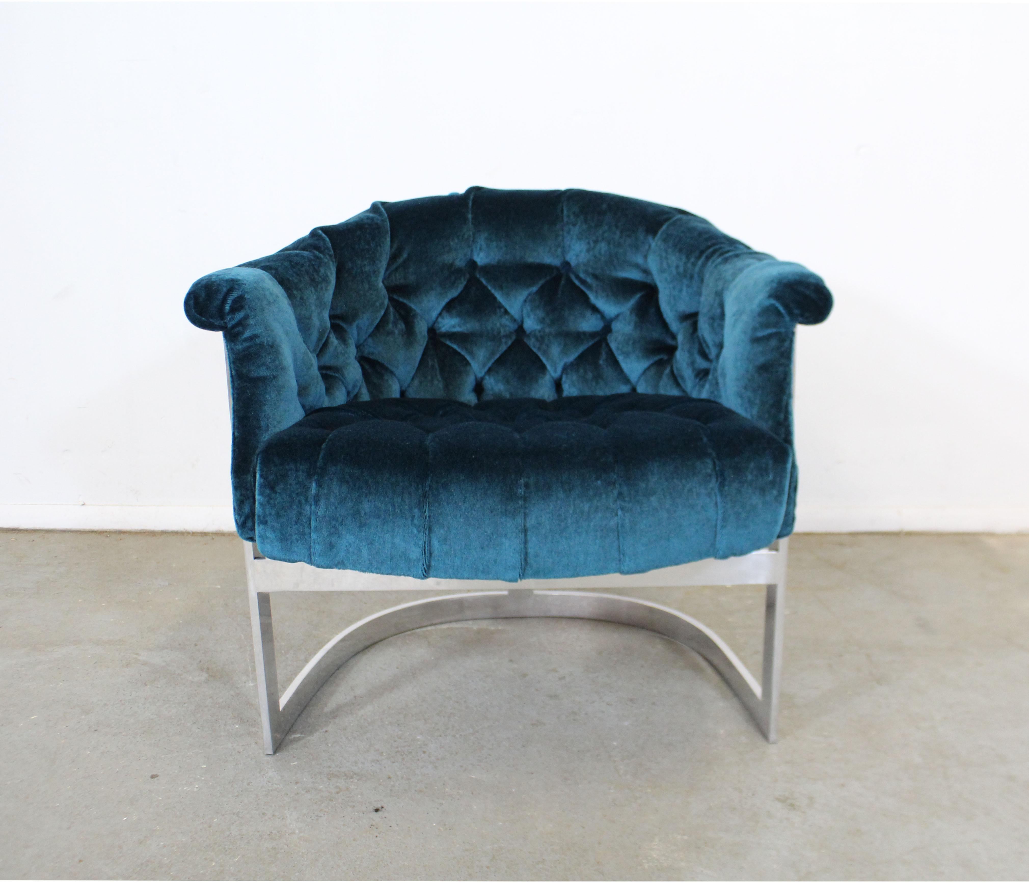 Offered is a beautifully restored vintage Mid-Century Modern lounge chair by John Stuart. This chair has been reupholstered with Jim Thompson 'Peacock' crushed velvet fabric. Features a steel base and tufted seat and back. In excellent restored