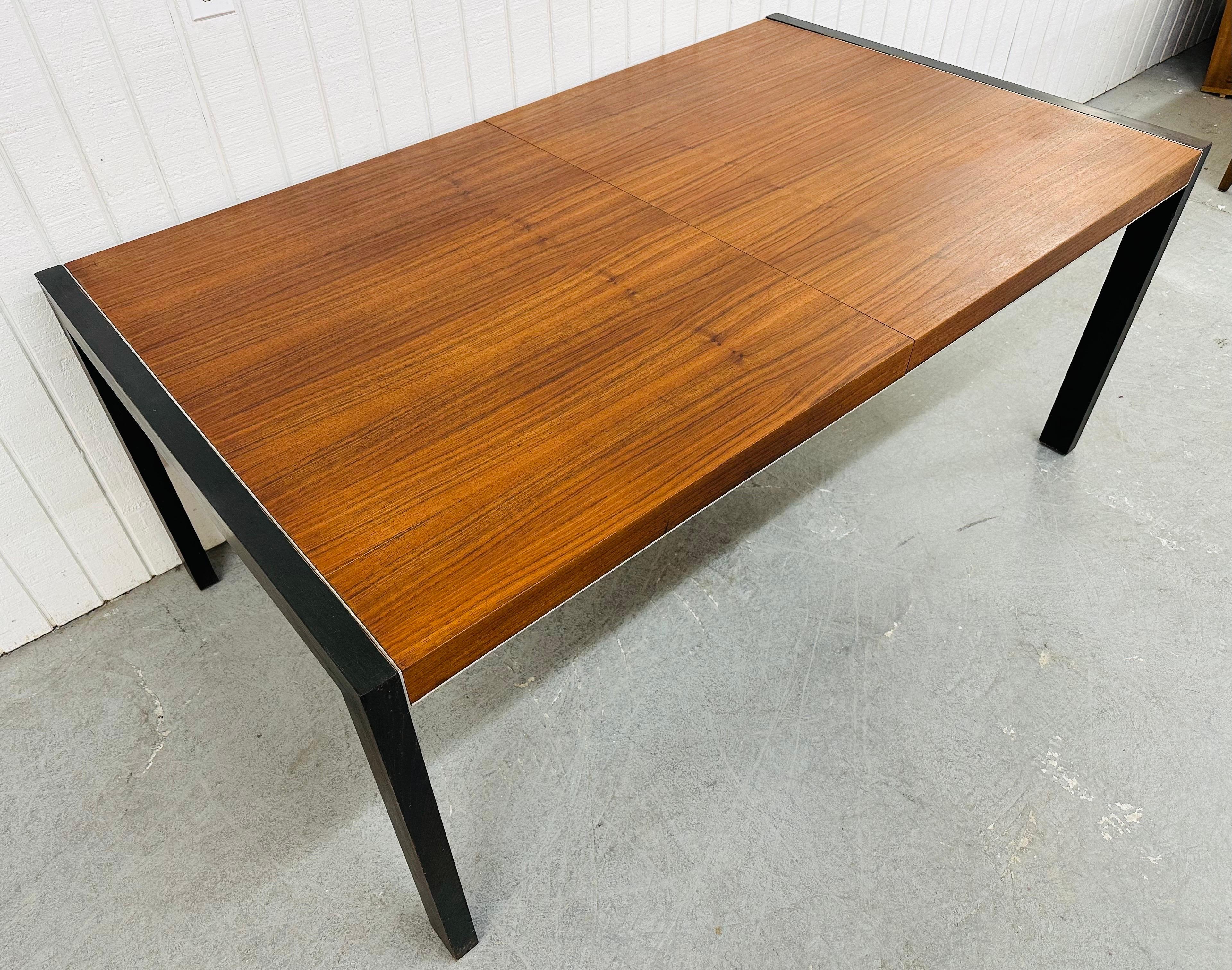 This listing is for a Mid-Century Modern John Stuart Walnut Dining Table. Featuring a straight line design, removable black legs, chrome accent, and a beautiful rectangular walnut top. This is an exceptional combination of quality and design by John
