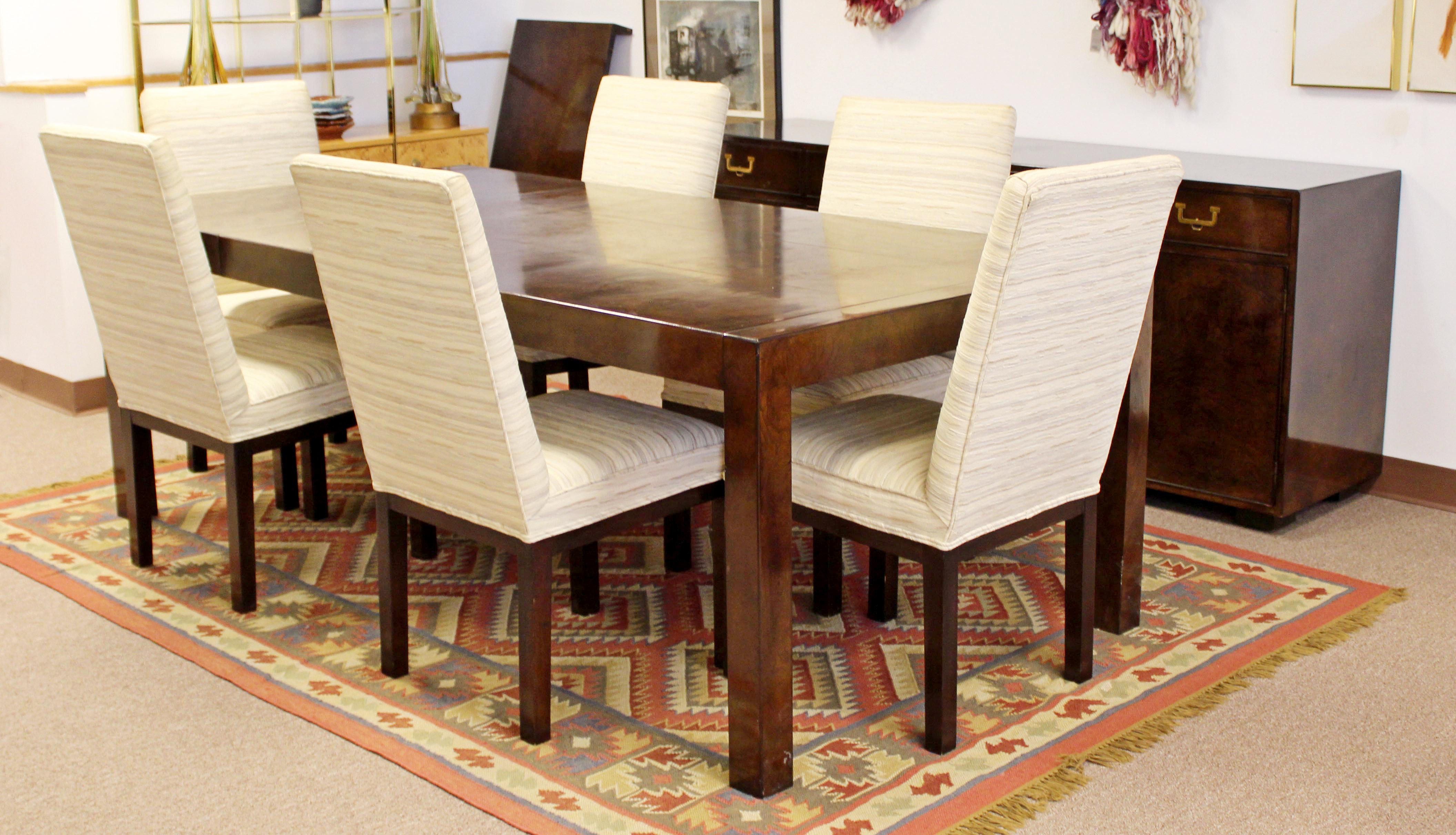 For your consideration is a maginificent dining room set, including a burl wood credenza, with brass pulls and two shelves and two drawers, a burl wood dining table with two leaves, and a set of six side chairs, by John Widdicomb, circa 1950s. In