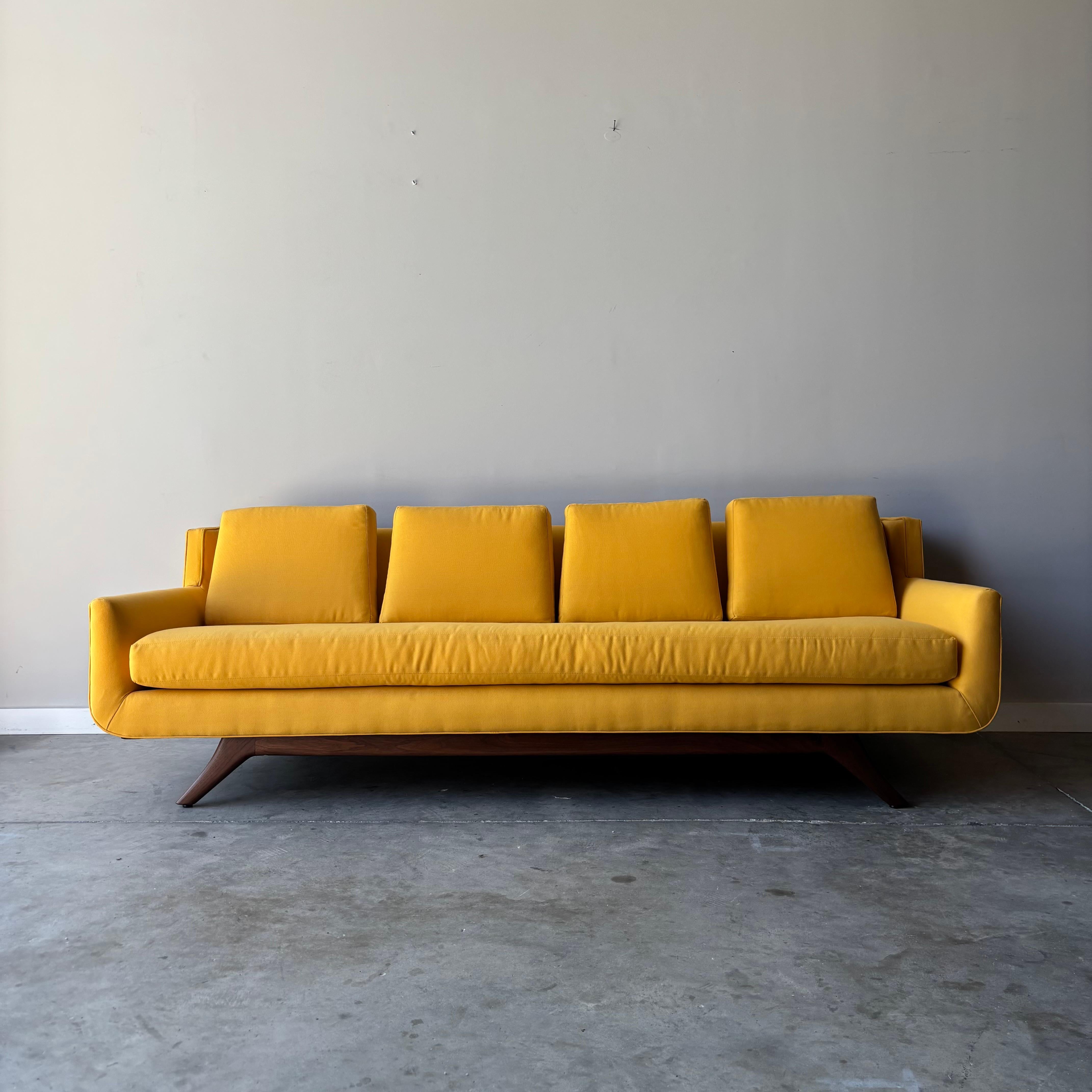 
Exceptional mid-century modern gondola sofa by celebrated designer Josef Otmar, featuring his signature flowing lines and masterful woodworking. This stunning piece showcases the sculptural aesthetic that made Otmar a key figure in American studio