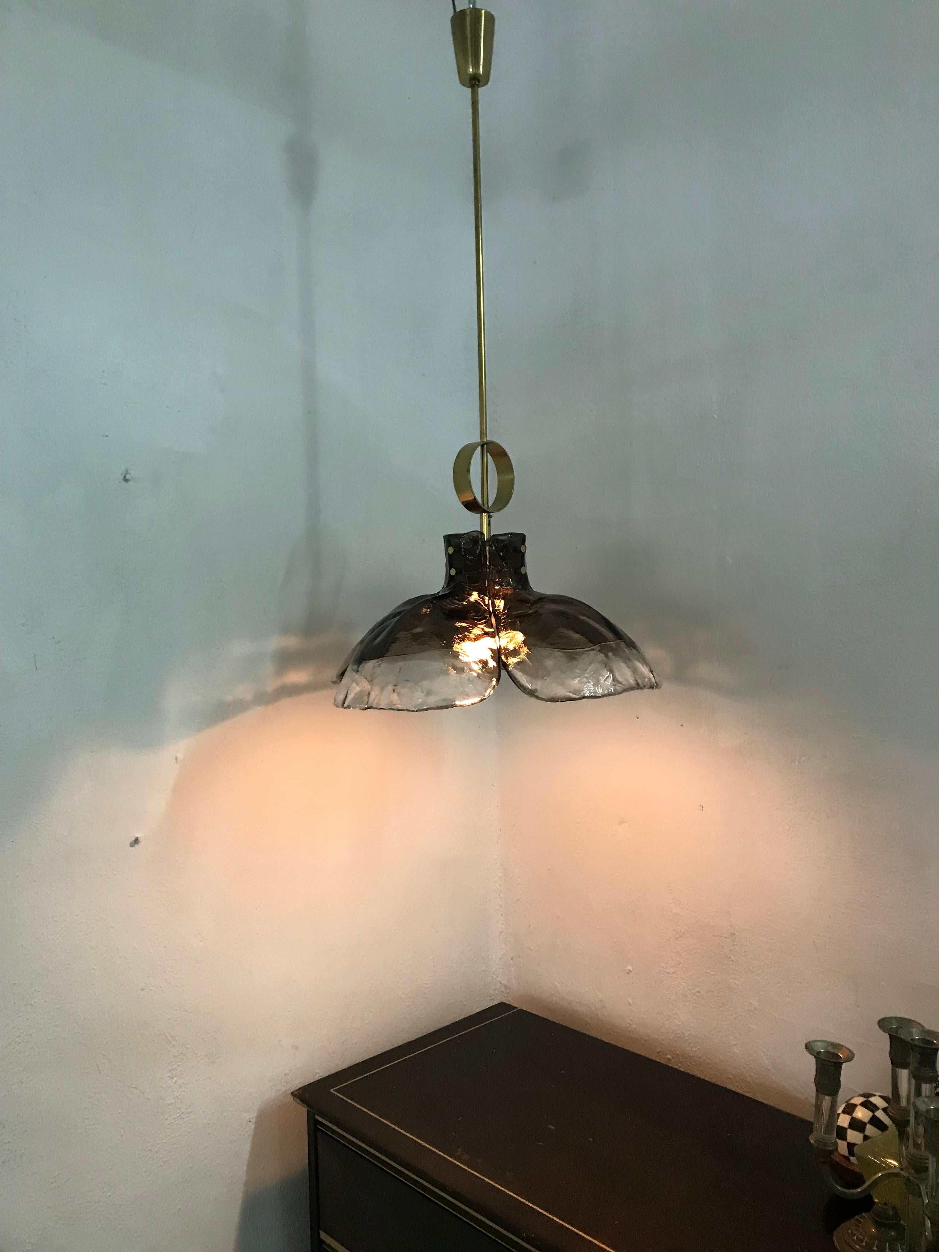 Mid-Century Modern pendant light by Kalmar, circa 1970, consisting of 4 ´petals´ in clear and white blown glass and brass hardware, this Line of Lighting is often attributed to Carlo Nason but we can´t confirm this at this point. Original label is