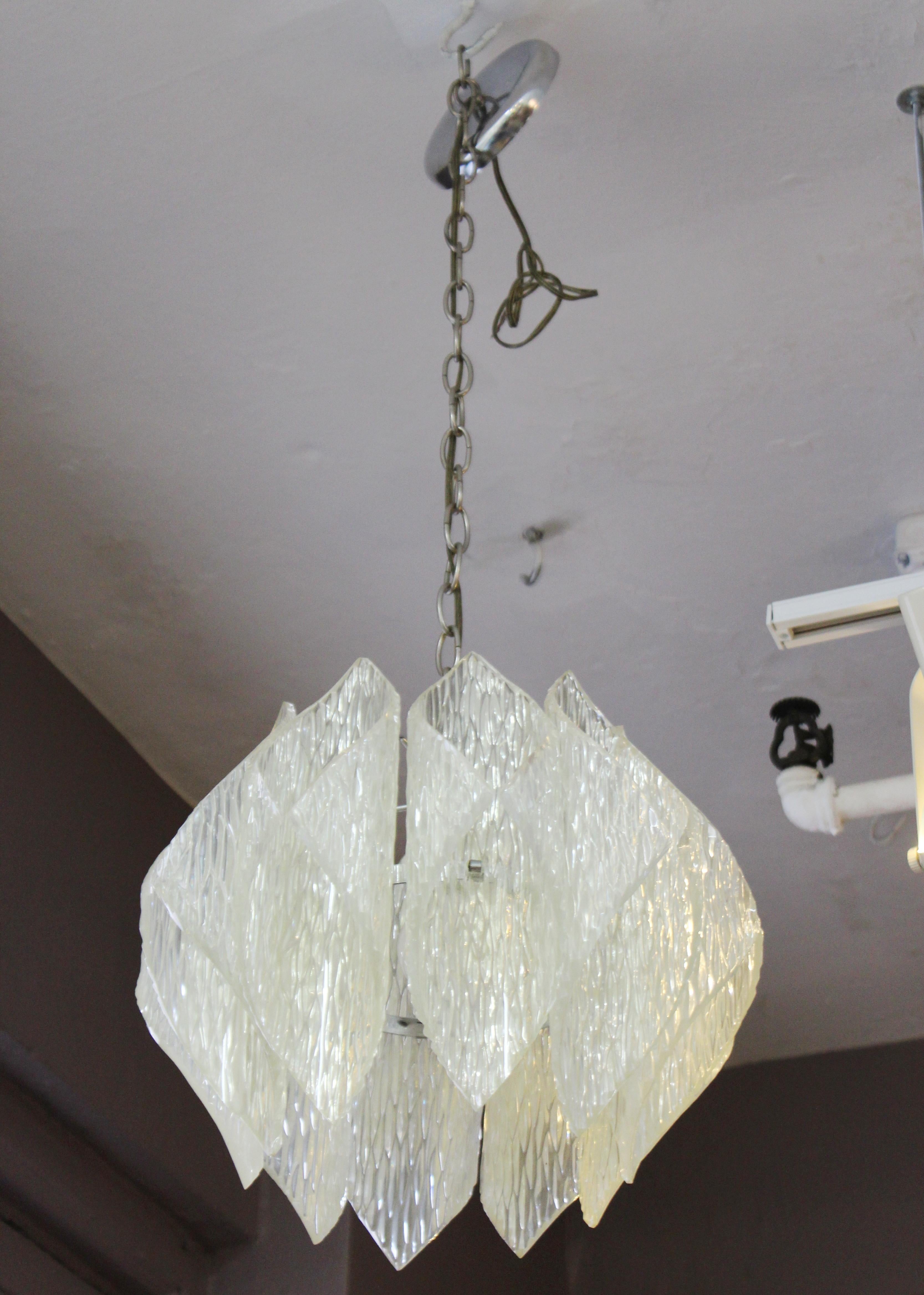 Mid-Century Modern Kalmar style chandelier pendant with a metal frame with a shade made of folded acrylic elements. The piece is in good vintage condition with age appropriate wear and patina.