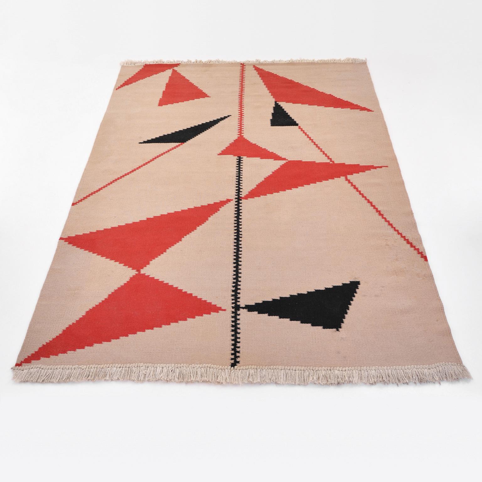 Mid-Century Modern handwoven kelim rug with red and black geometric ornament. The simple geometric decoration of this rug, manufactured in Czechoslovakia in the 1950s, is stylistically influenced by the modern vision of Marie Hoppe-Teinitzerová