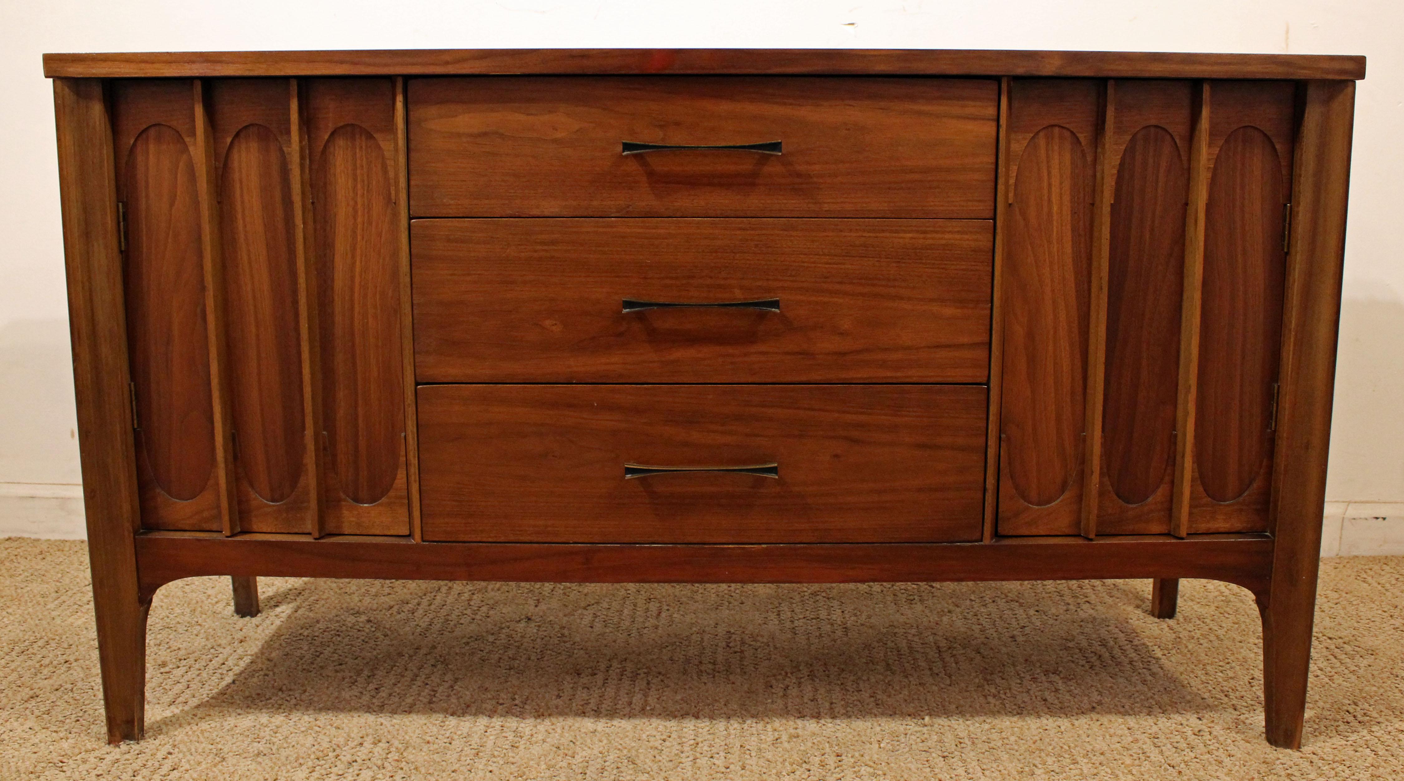 Offered is a Mid-Century Modern credenza. The piece has a nice shape and modern lines. It is made of walnut, featuring two doors with inside shelving and three center drawers. The top has been refinished. It is not signed. 

Dimensions:
47.25