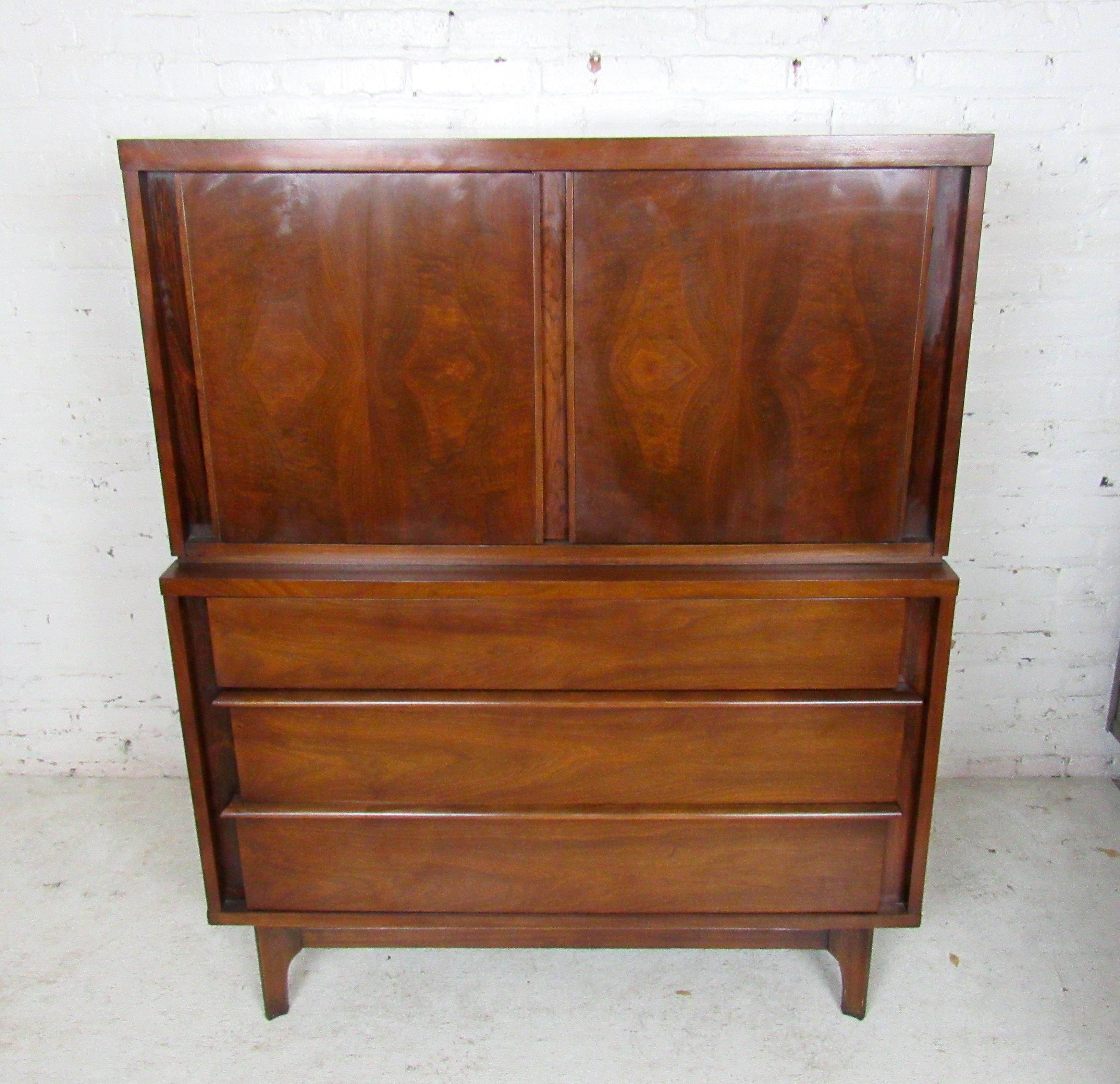 Vintage modern highboy dresser by Kent Coffey featuring three large drawers on the bottom, two more drawers behind the top doors.

Please confirm item location - NY or NJ - with dealer).
