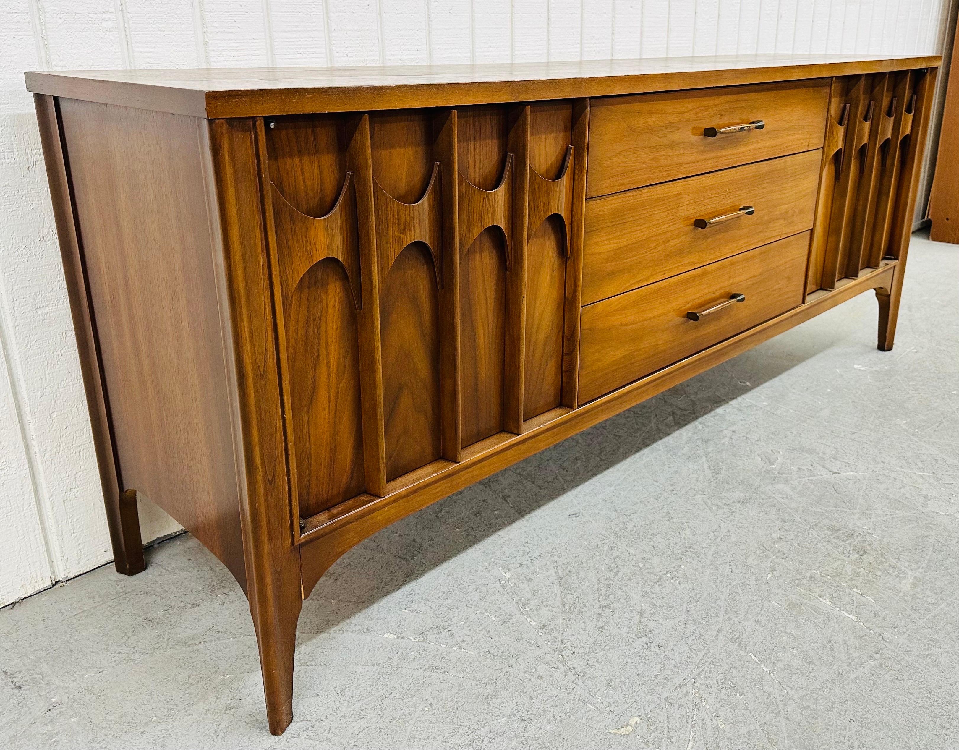 This listing is for a Mid-Century Modern Kent Coffey Perspecta Walnut Dresser. Featuring a straight line design, three drawers on each side with sculpted rosewood pulls, three larger drawers in the center with original hardware, modern legs, and a