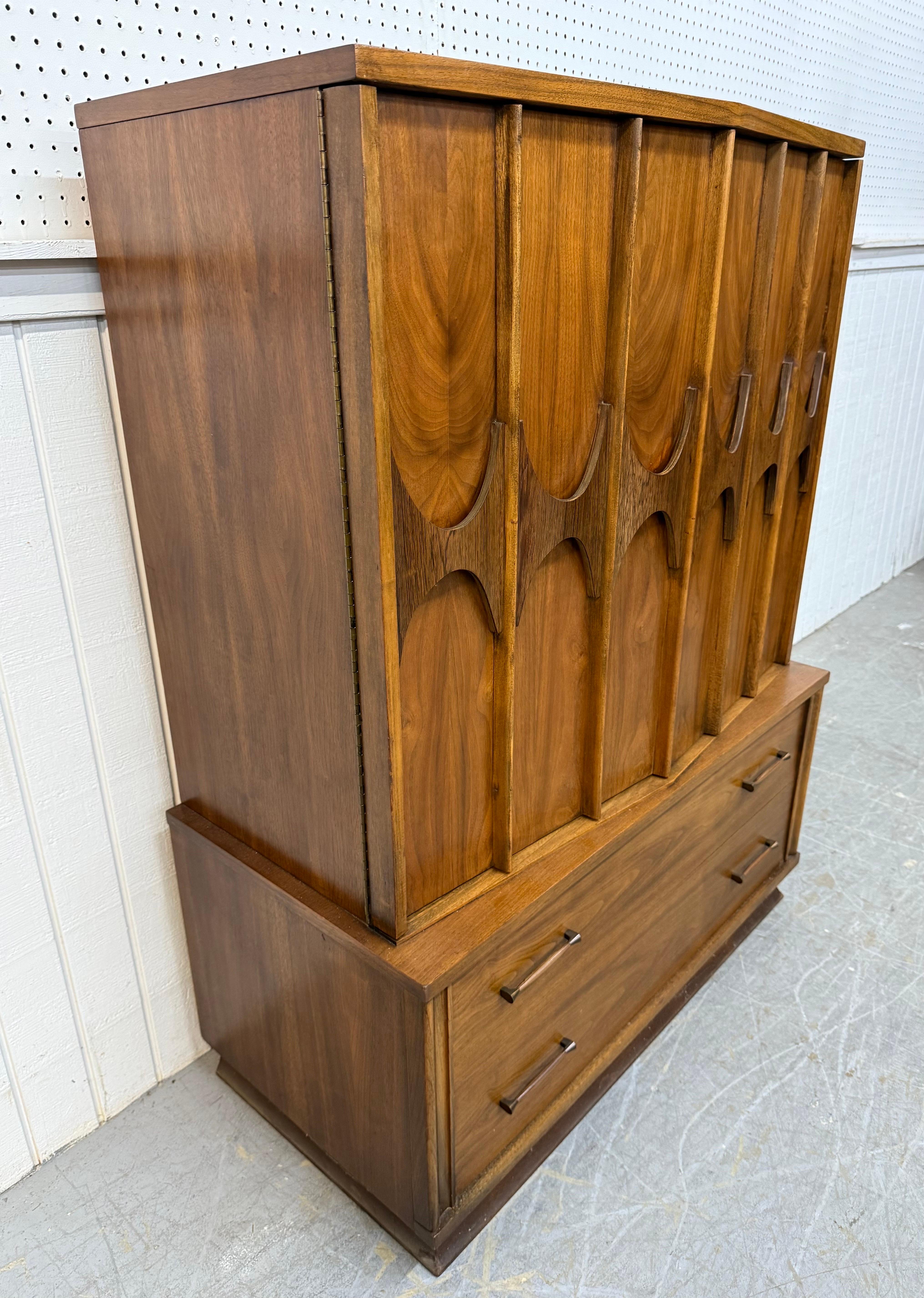 This listing is for a Mid-Century Modern Kent Coffey Perspecta Walnut Armoire. Featuring a straight line design, two large doors with sculpted rosewood pulls, three hidden drawers for storage, two larger drawers at the bottom with original hardware,