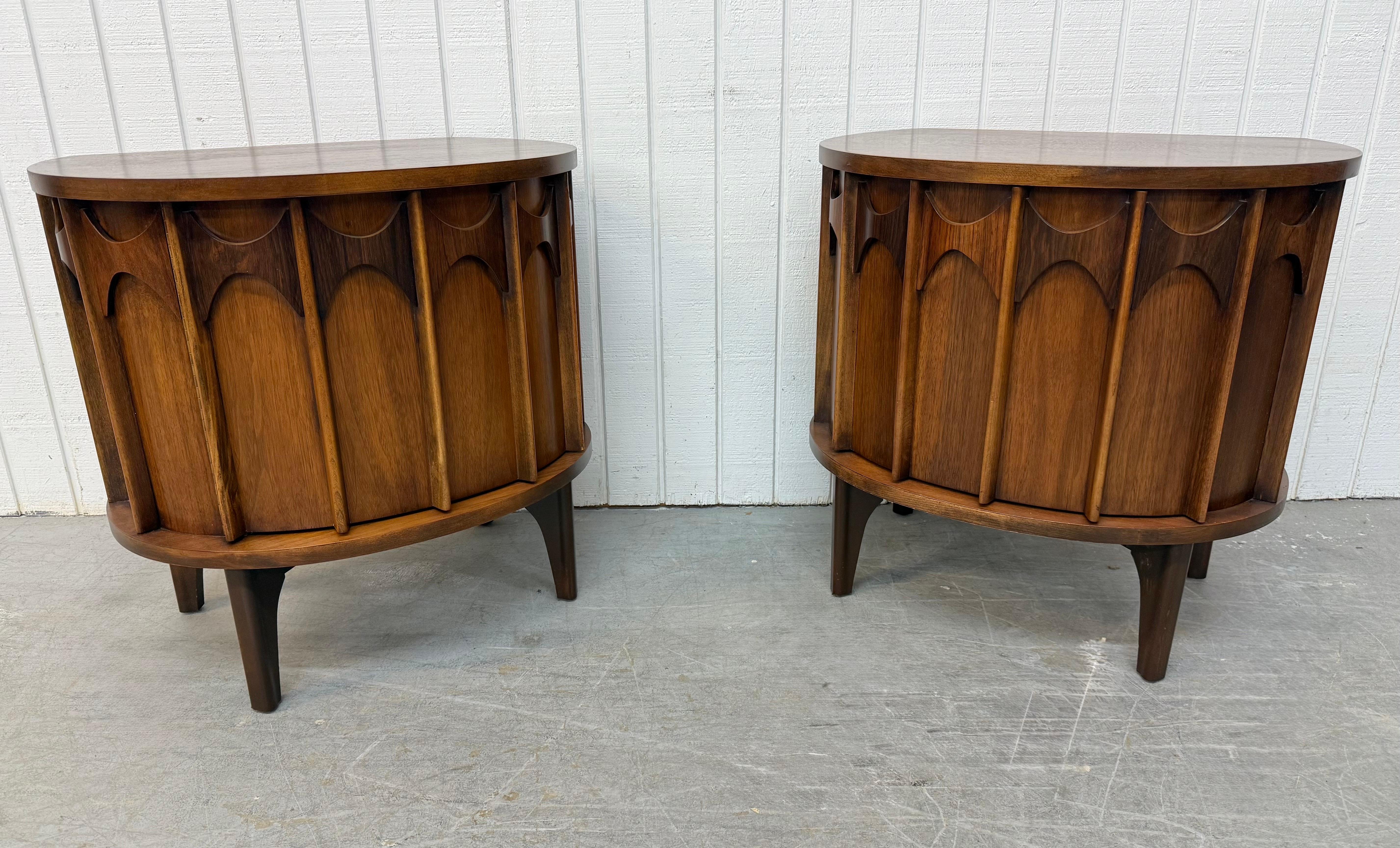 This listing is for a pair of Mid-Century Modern Kent Coffey Perspecta Walnut Commode Nightstands. Featuring a rounded front design, solid wood top, single door with sculpted rosewood pulls, interior drawer with storage space, modern legs, and a