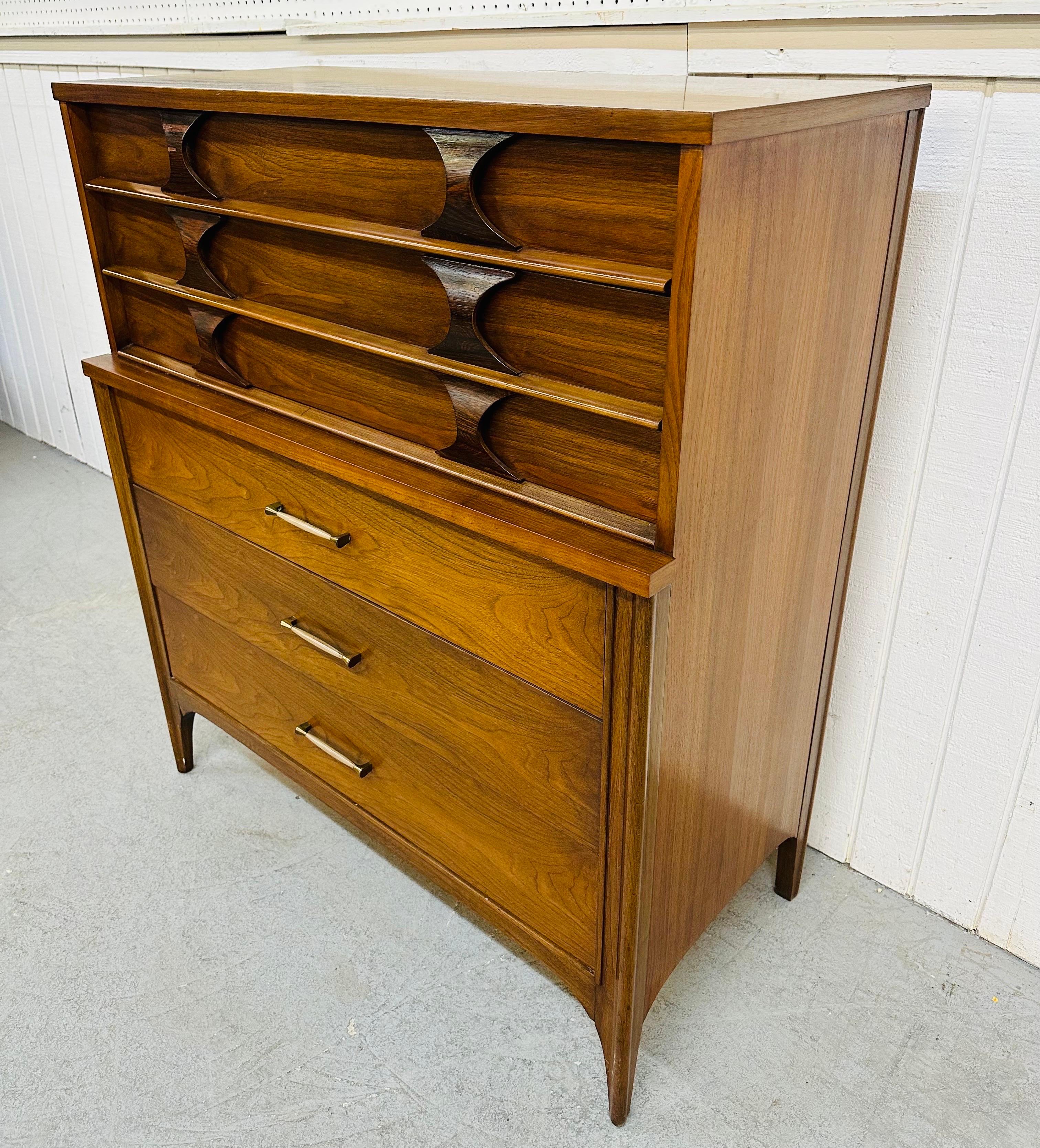 This listing is for a Mid-Century Modern Kent Coffey Perspecta Walnut High Chest. Featuring two top drawers with sculpted rosewood pulls, three larger drawers at the bottom with original hardware, and a beautiful walnut finish. This is an iconic
