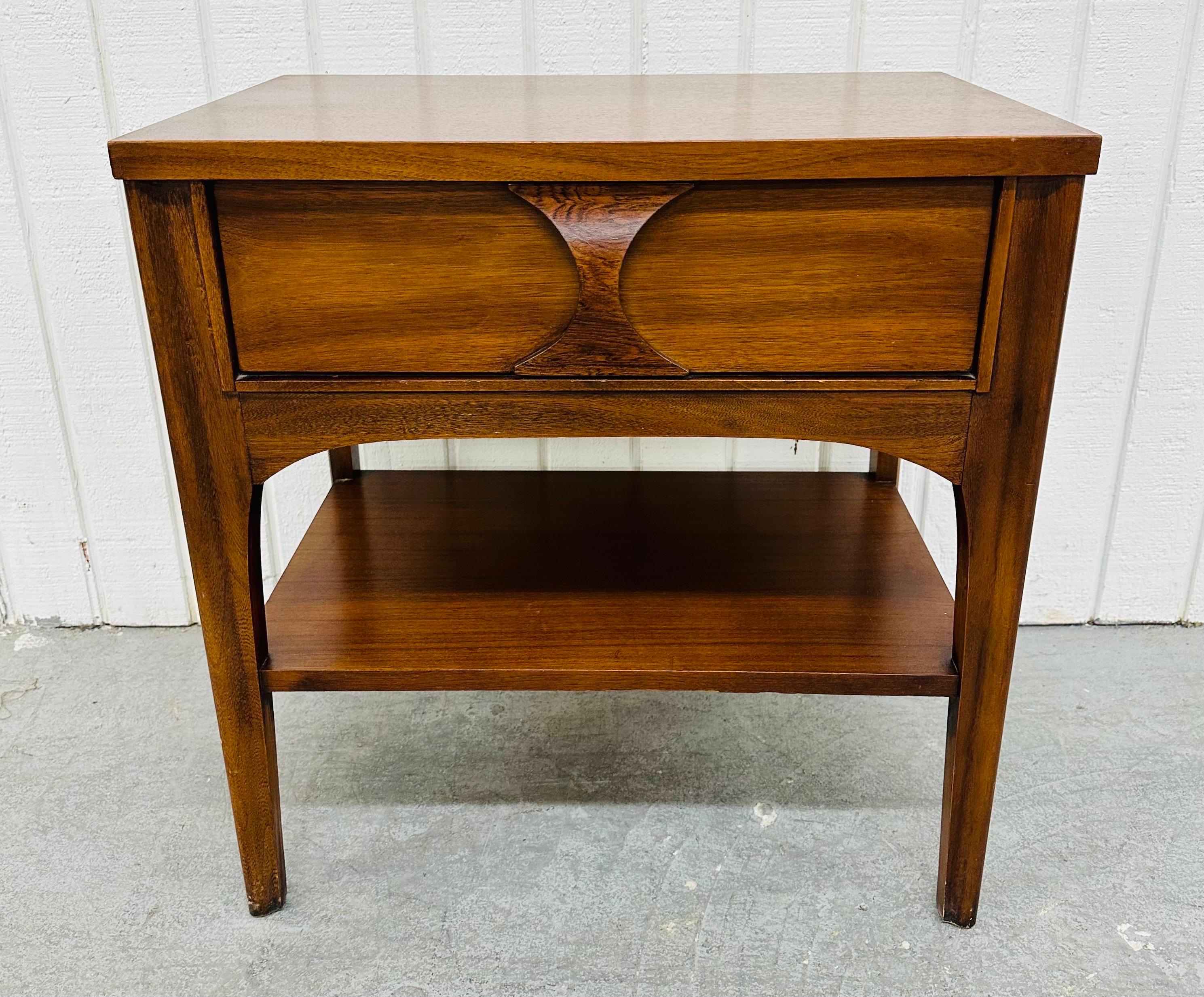 This listing is for a Mid-Century Modern Kent Coffey Perspecta Walnut Nightstand. Featuring a straight line design, rectangular top, single drawer for storage, sculpted rosewood pull, bottom shelf for more storage space, and a beautiful walnut