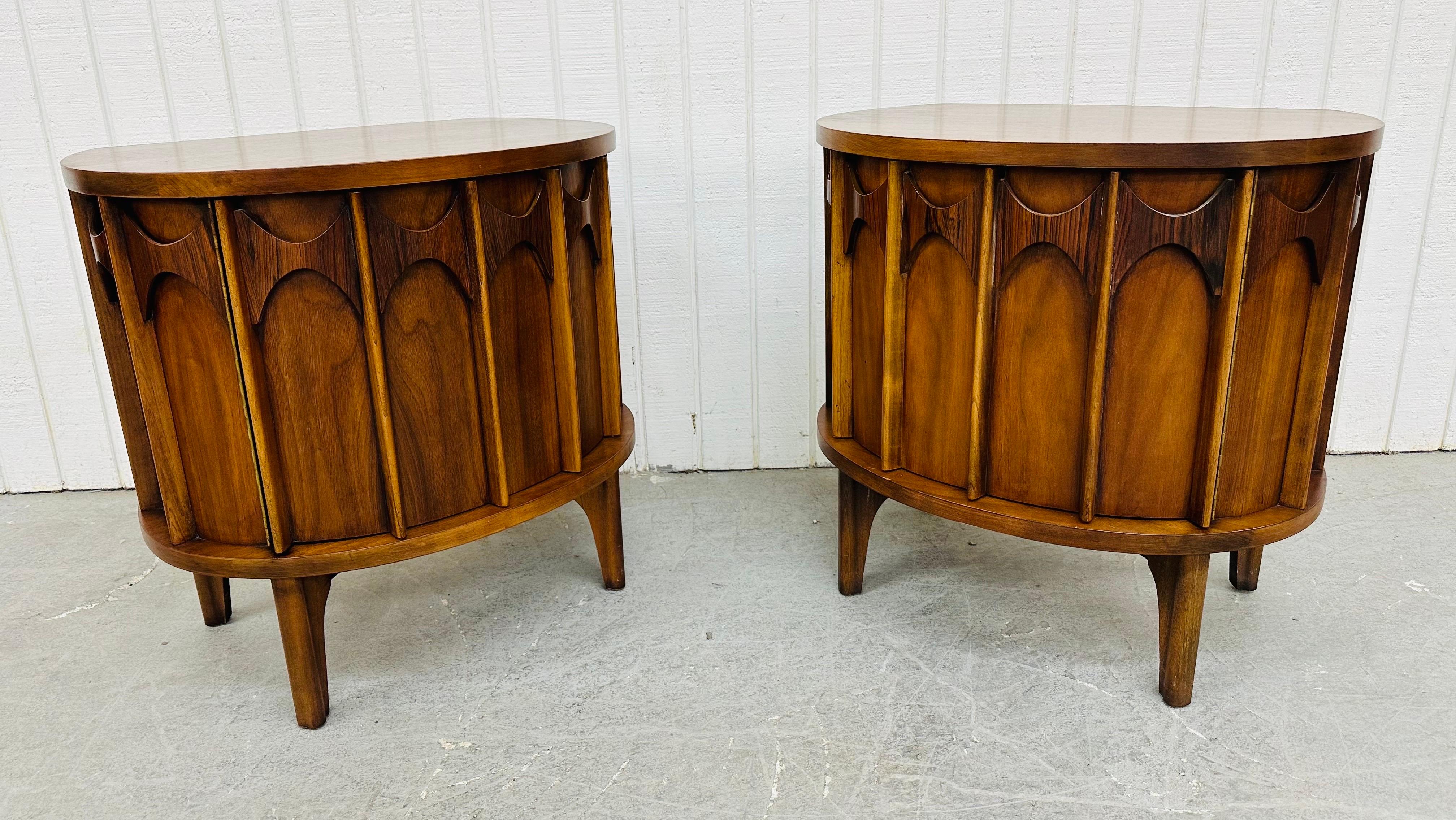 This listing is for a pair of Mid-Century Modern Kent Coffey Perspecta Walnut Nightstands. Featuring a rounded design, single door that opens up to storage space, a single drawer, sculpted rosewood across the top, modern legs, and a beautiful walnut