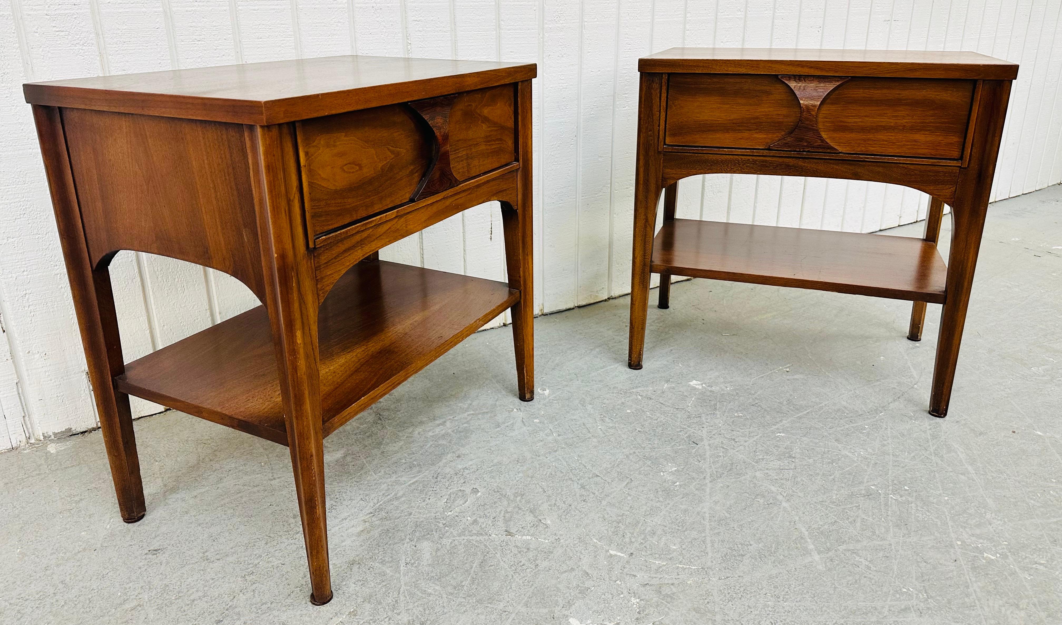 This listing is for a pair of Mid-Century Modern Kent Coffey Perspecta Walnut Nightstands. Featuring a straight line design, single drawer with sculpted rosewood pull, long modern legs, bottom shelf for storage, and a beautiful walnut finish. This