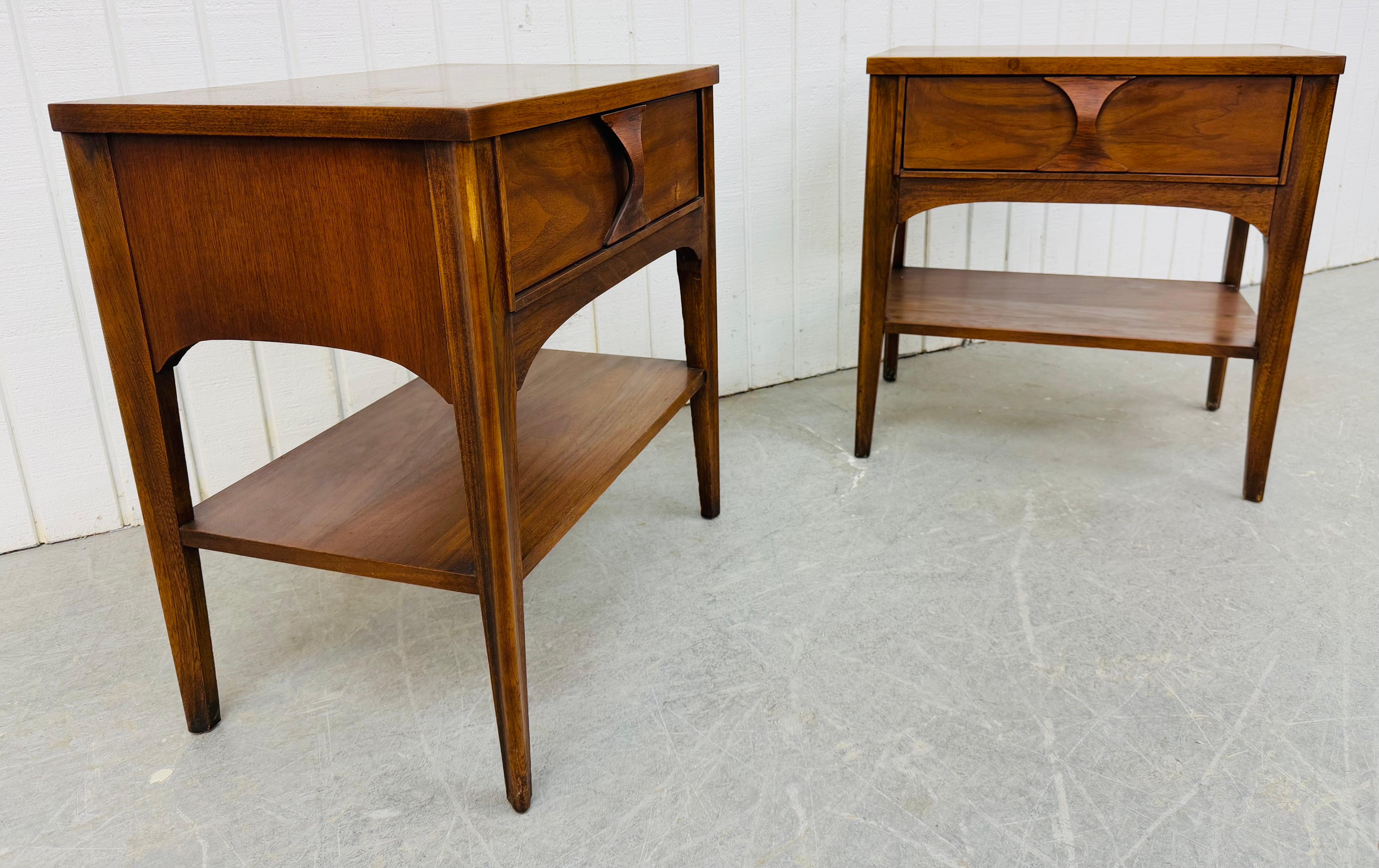 This listing is for a pair of Mid-Century Modern Kent Coffey Perspecta Walnut Nightstands. Featuring a straight line design, rectangular tops, single drawer with sculpted pull, bottom shelf for storage, long modern legs, and a beautiful walnut