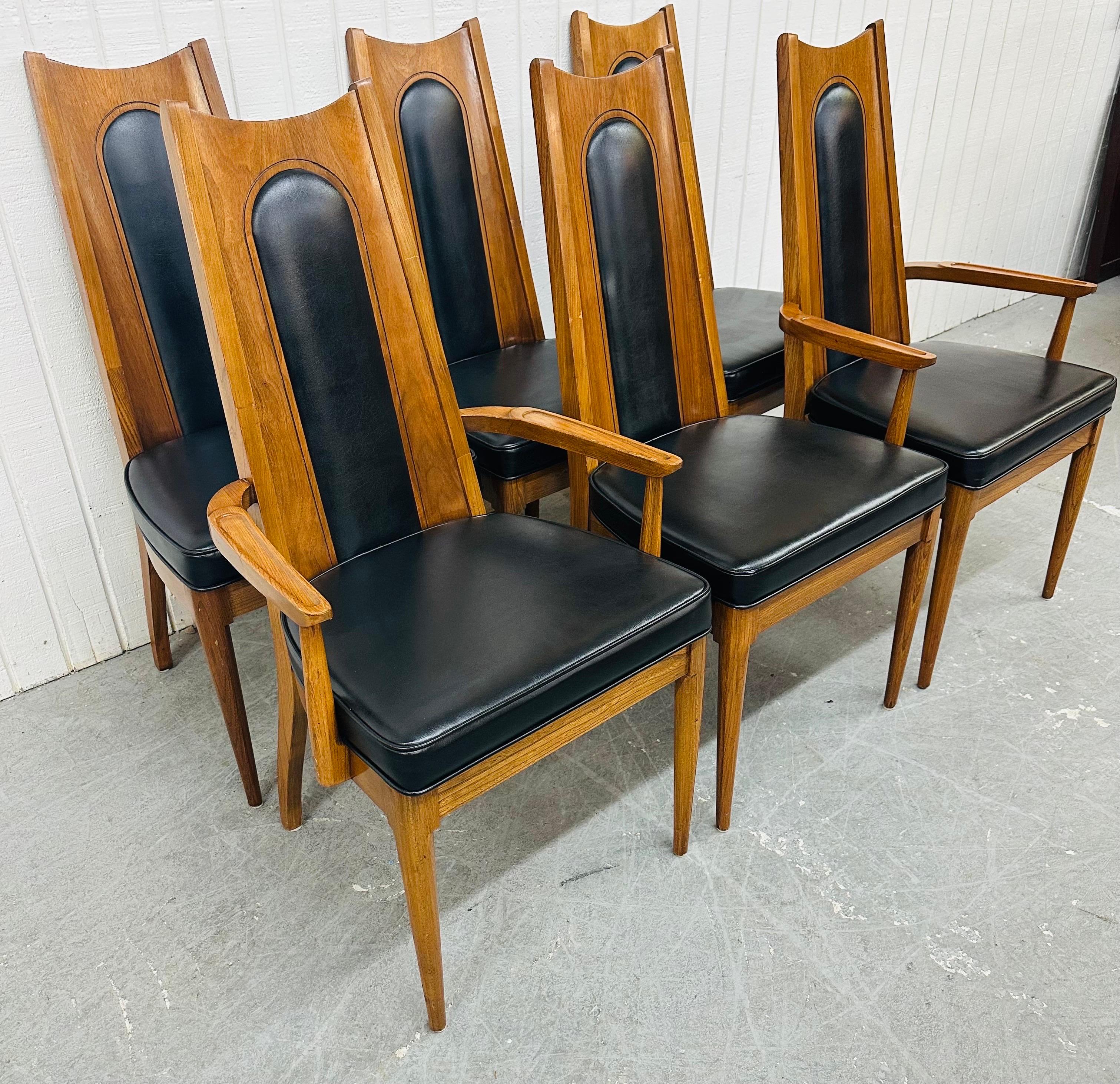 This listing is for a set of six Mid-Century Modern Kent Coffey Walnut Dining Chairs. Featuring a two arm chairs, four side chairs, walnut frames, black vinyl upholstery, and a high back design. This is an exceptional combination of quality and
