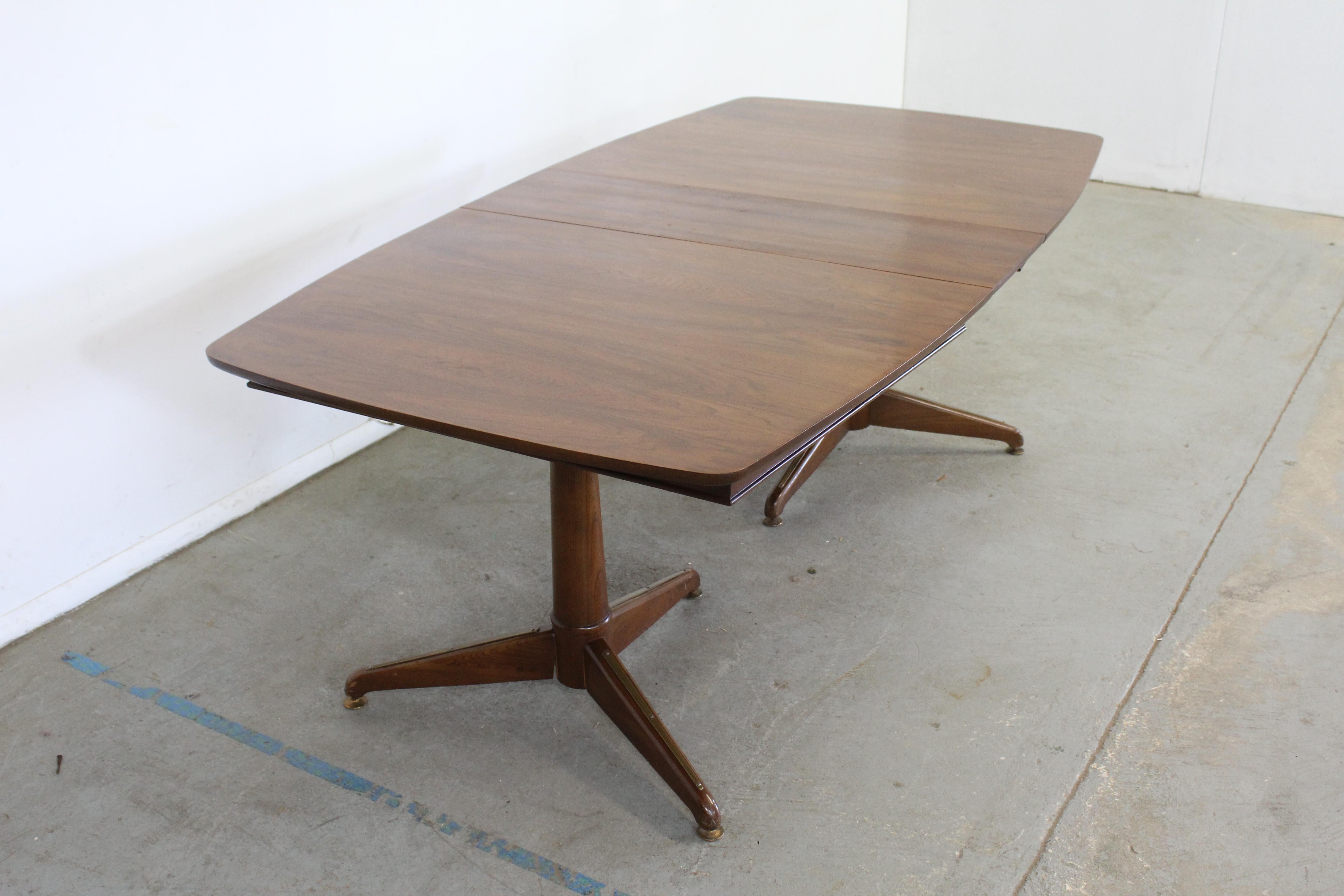 Mid-Century Modern Kent Coffey walnut perspecta dining table

Offered is a large Mid-Century Modern conference/dining table. This table has been recently restored with a refinished walnut 
and has a 12