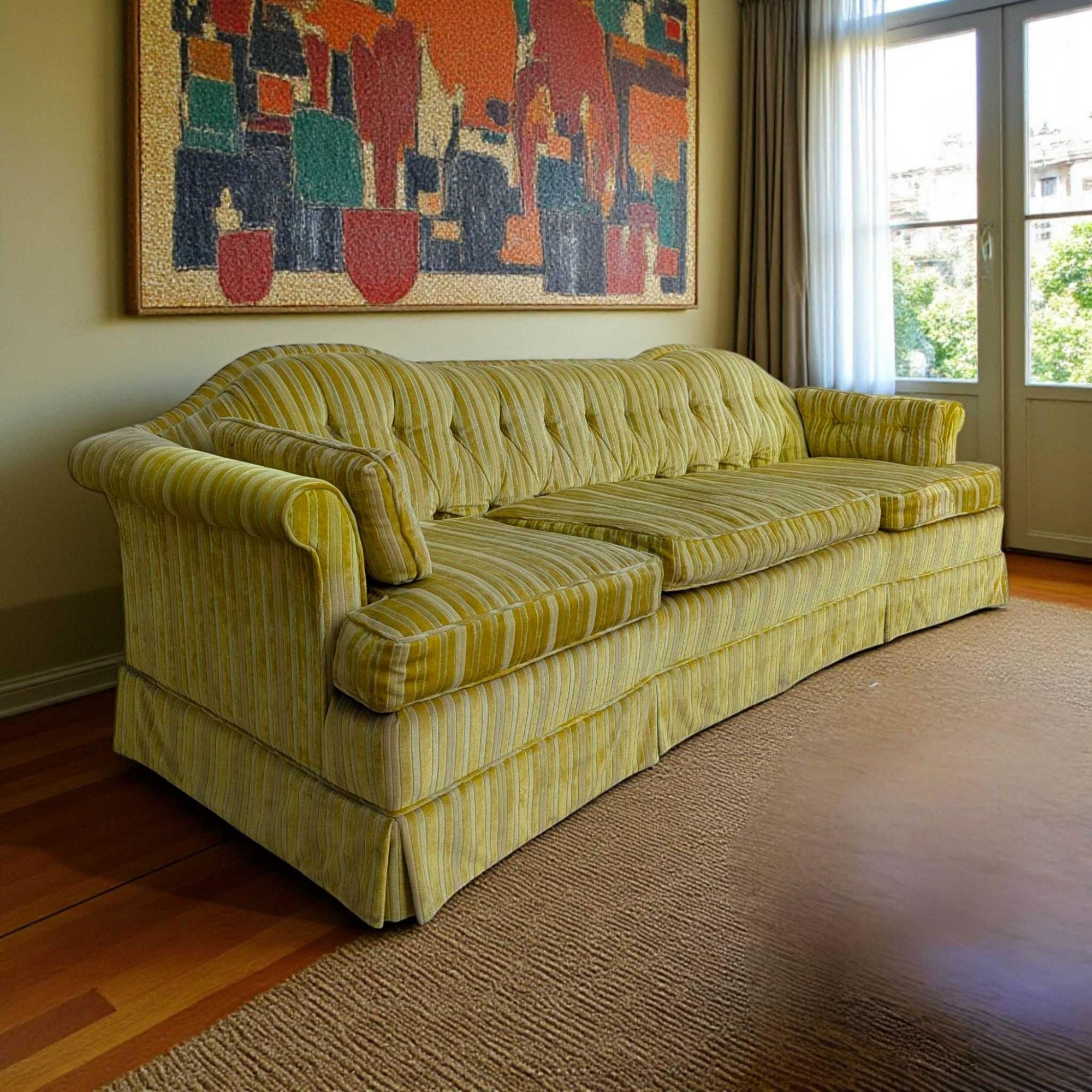 An elegant Mid-Century Modern sofa by Key City Furniture Company, upholstered in a vibrant striped yellow fabric, featuring a tufted back and a unique shape.

This sofa combines a striking aesthetic with comfortable design, making it a bold