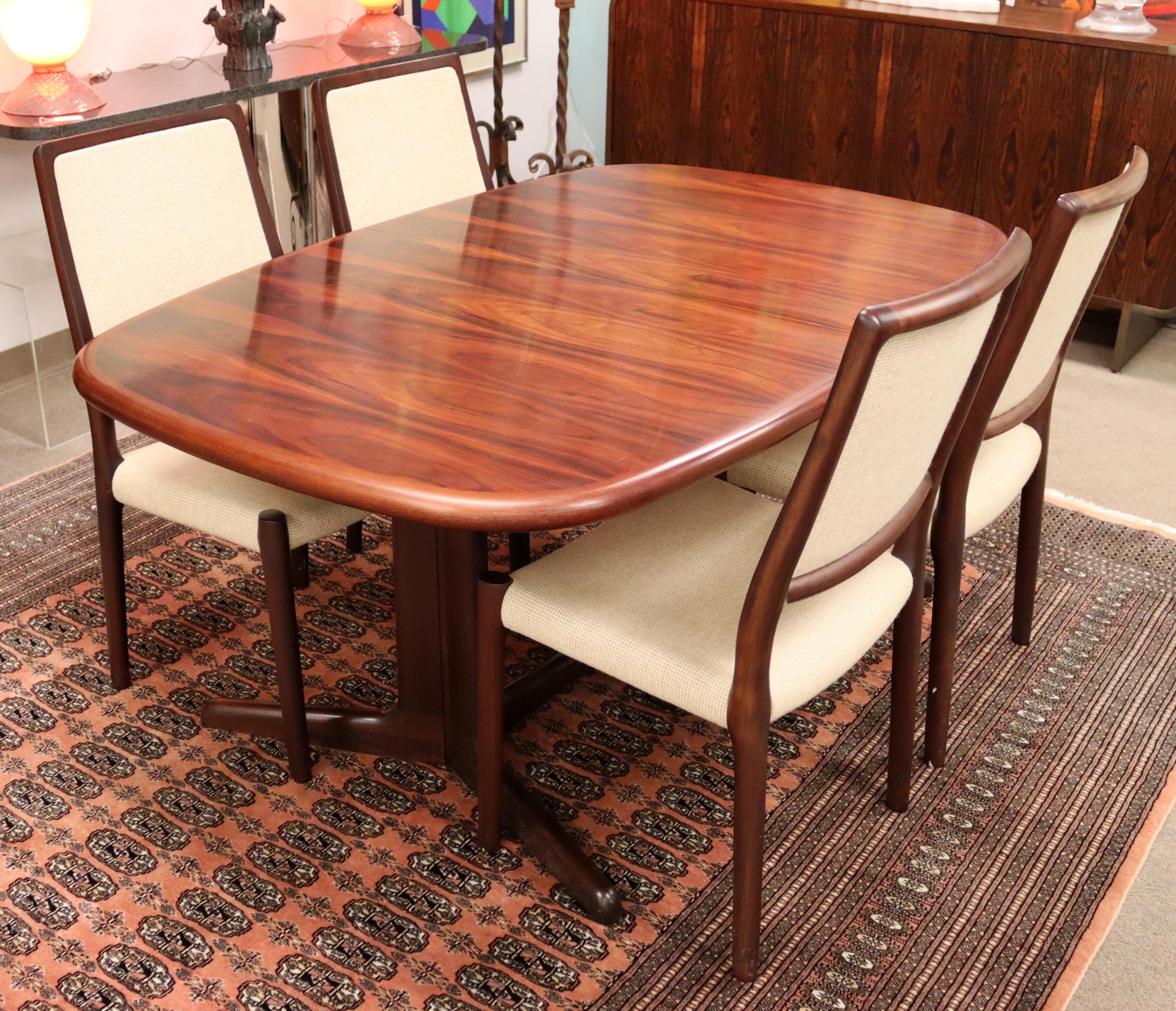 For your consideration is an incredible, rosewood dining set and credenza, including four chairs, by Kibaek Mobelfabrik, made in Denmark, circa the 1960s. In excellent vintage condition. The dimensions of the credenza are 51