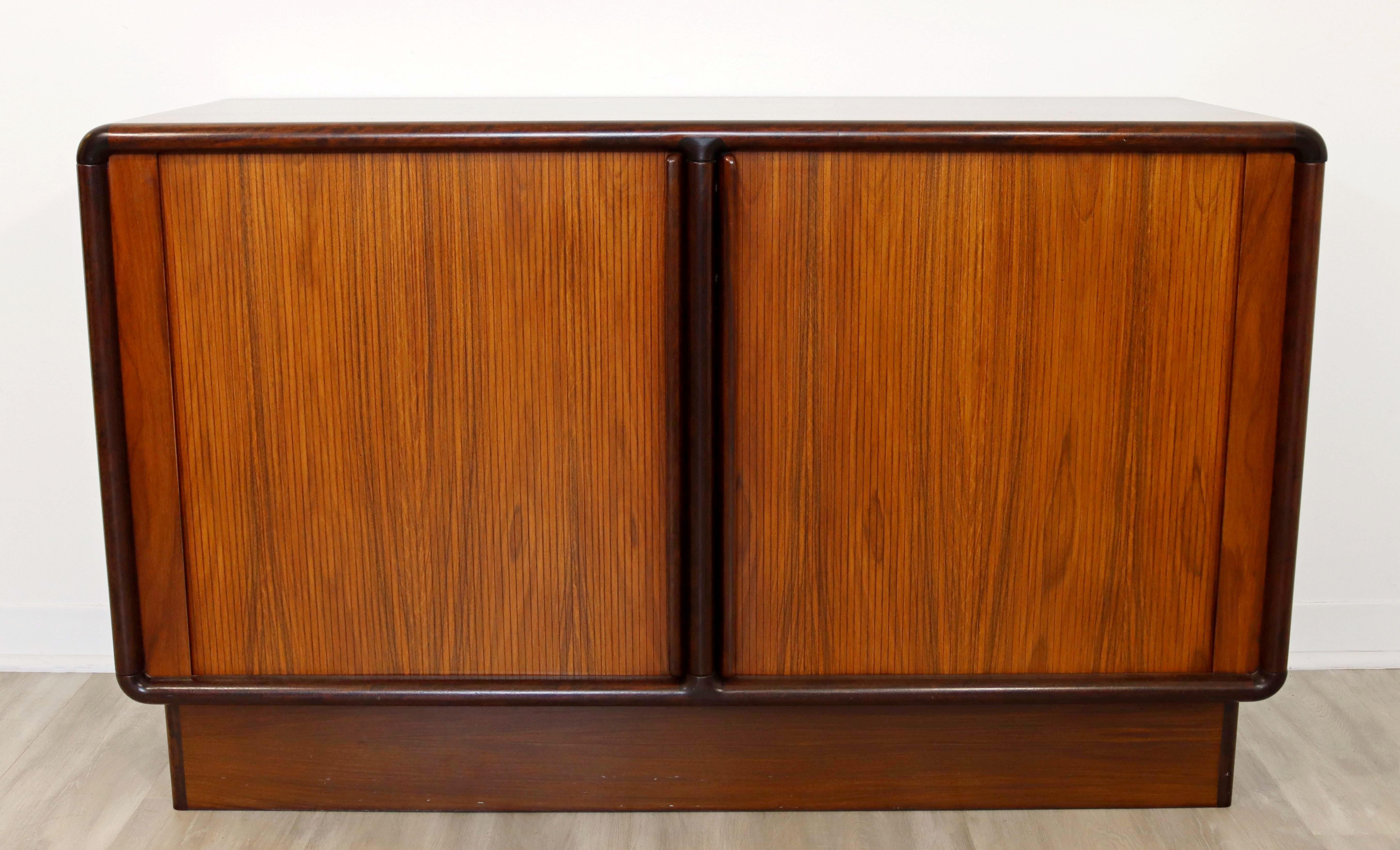 For your consideration is an exemplary, rosewood credenza, with sliding tambour doors, and two drawers, by Kibaek Mobelfabrik, made in Denmark, circa the 1960s. In excellent vintage condition. The dimensions are 51