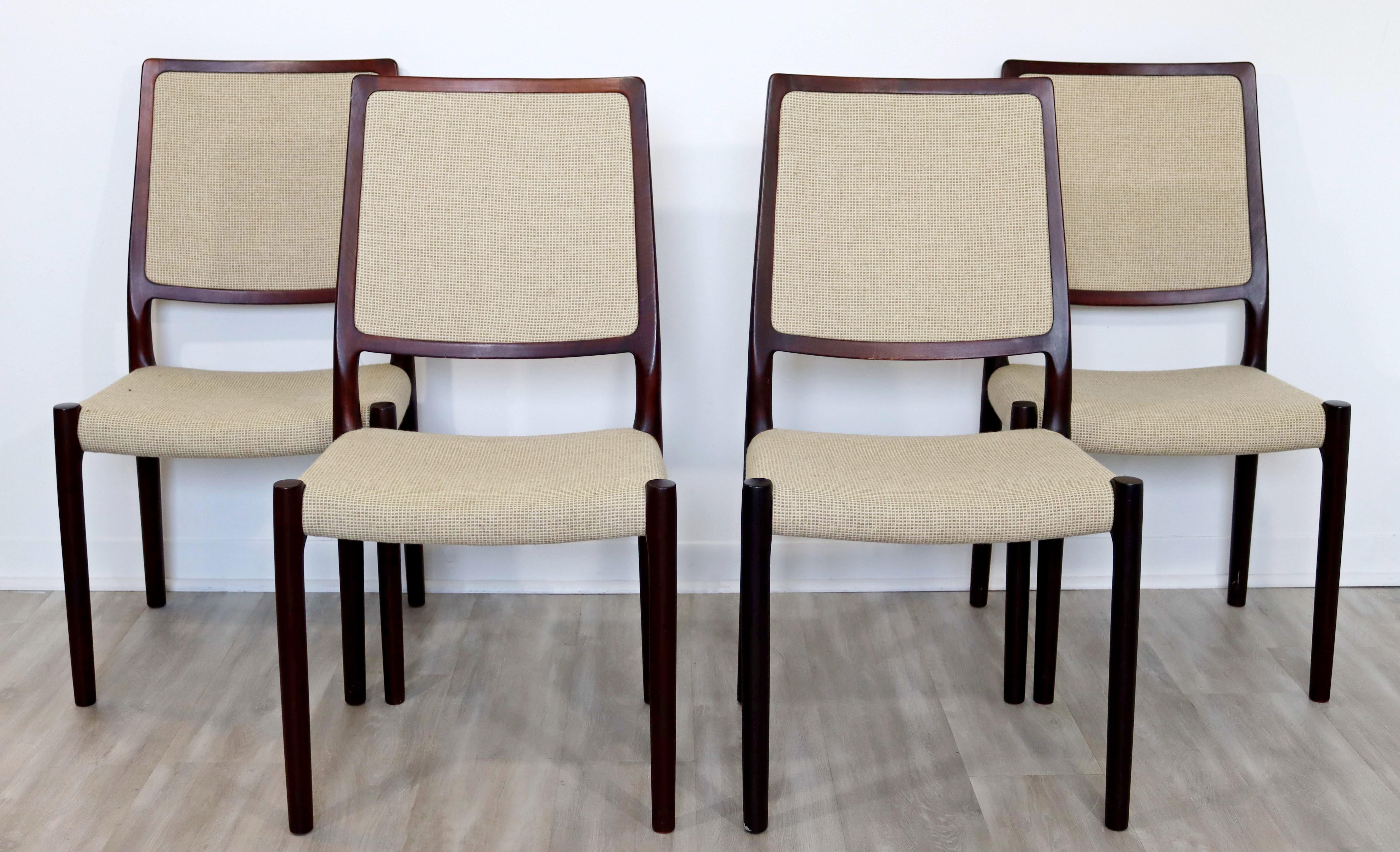 For your consideration is a ravishing, rosewood dining set, including four chairs and a table with two leaves, by Kibaek Mobelfabrik, made in Denmark, circa the 1960s. In excellent vintage condition. The dimensions of the table are 63