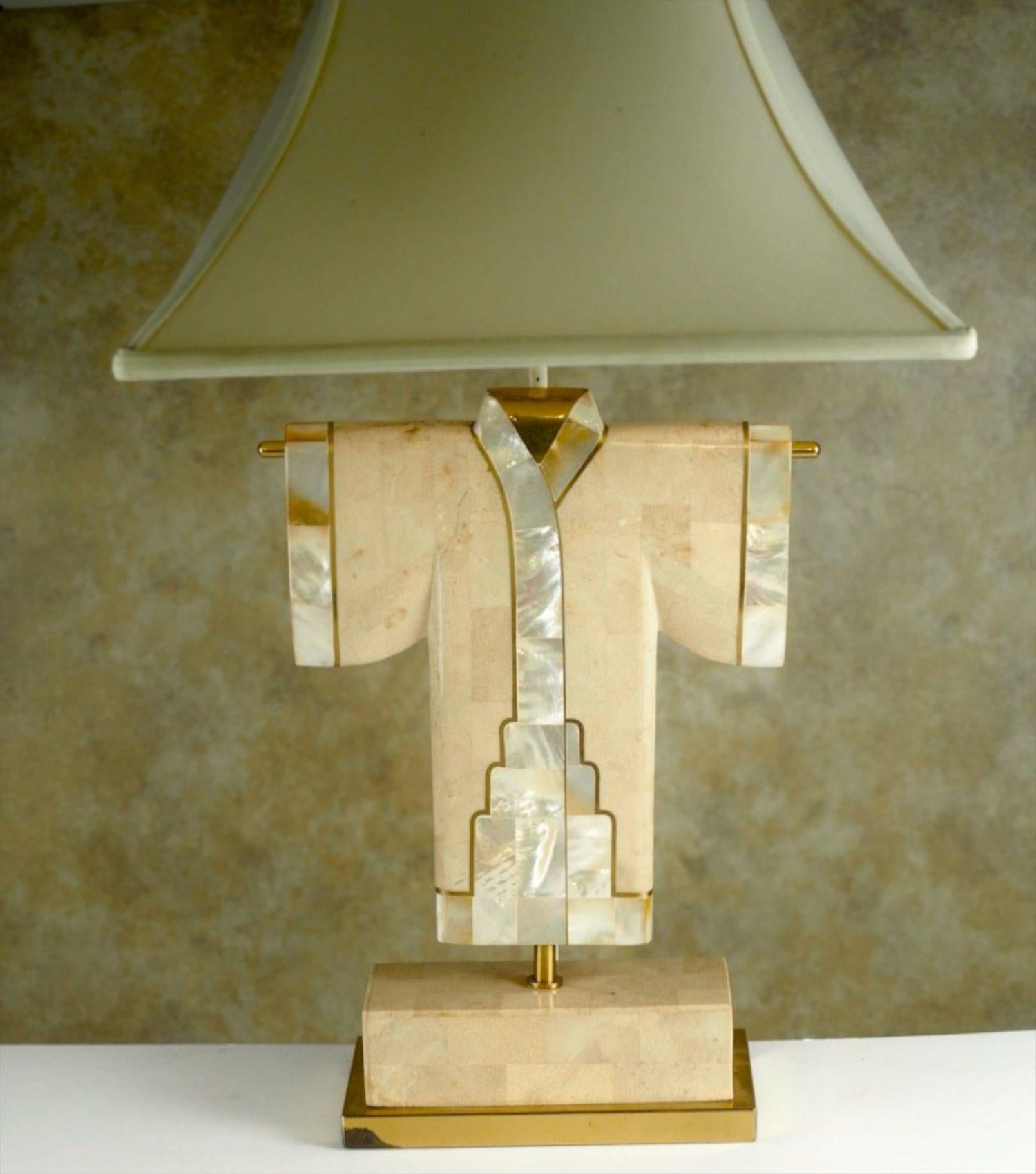 Mid-Century Modern table lamp, circa 1980, in mixed materials that include mother of pearl, brass, and tessellated stone. Measures: 28” to top of shade x 12” wide.