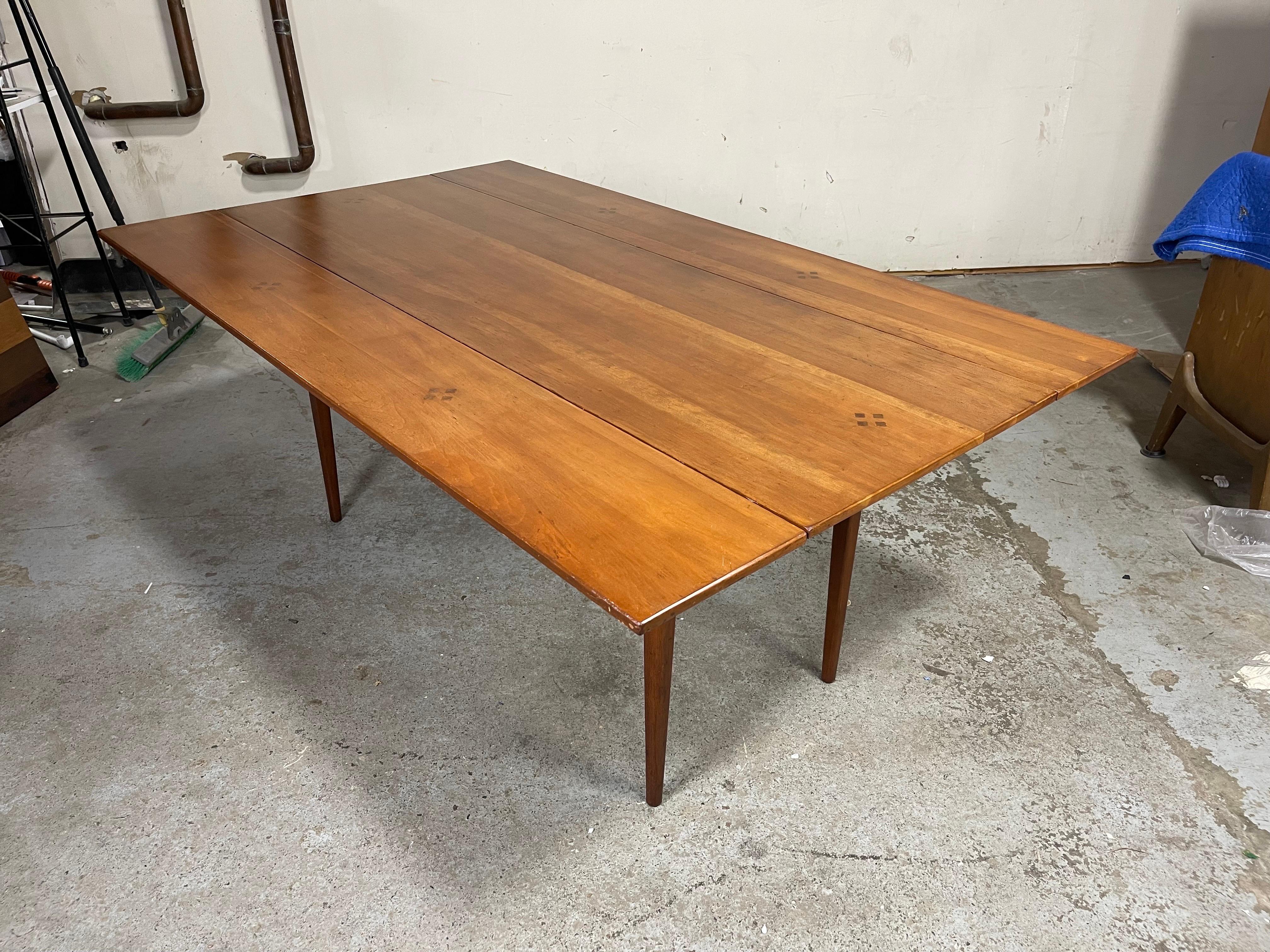 Excellent drop leaves table in a farmhouse rectangle style with rosewood inlay by Kipp Stewart. Original condition. Beautiful hard wood pull out supports with brass pulls on each side. Some wear. Please see photos and videos. 
Measures 70 x 42.5 x