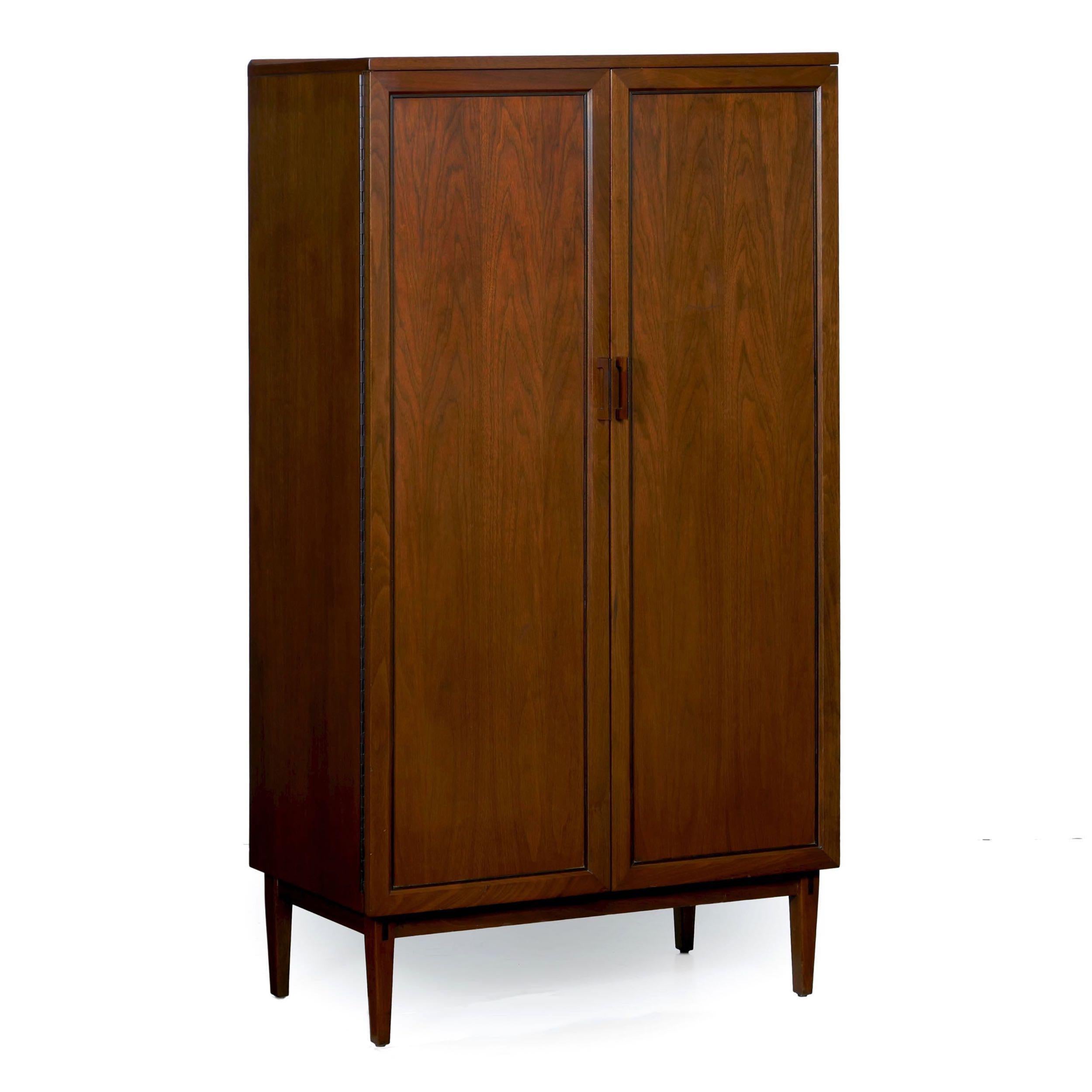 An interesting ten-drawer tall dresser designed by Kipp Stewart for the “Directional“ collection of Calvin Furniture Co., the cabinet form is sleek and austere. By utilizing a pair of doors instead of the long series of drawers, the case is tidy and