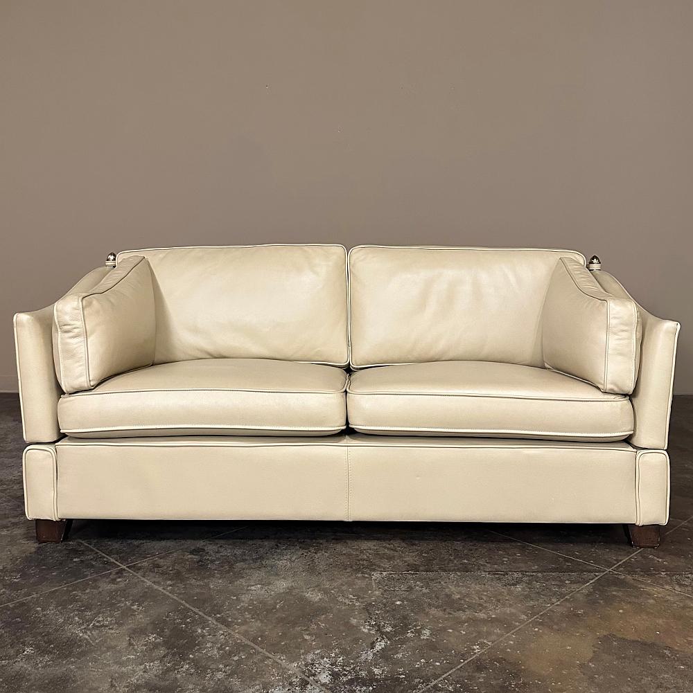 Mid-Century Modern Knole Leather Sofa is inspired by the design that has its roots in the 1600s in a grand country house of England, and has been the design to model most every sofa since! One particular trait is the hinged side arms, which can drop