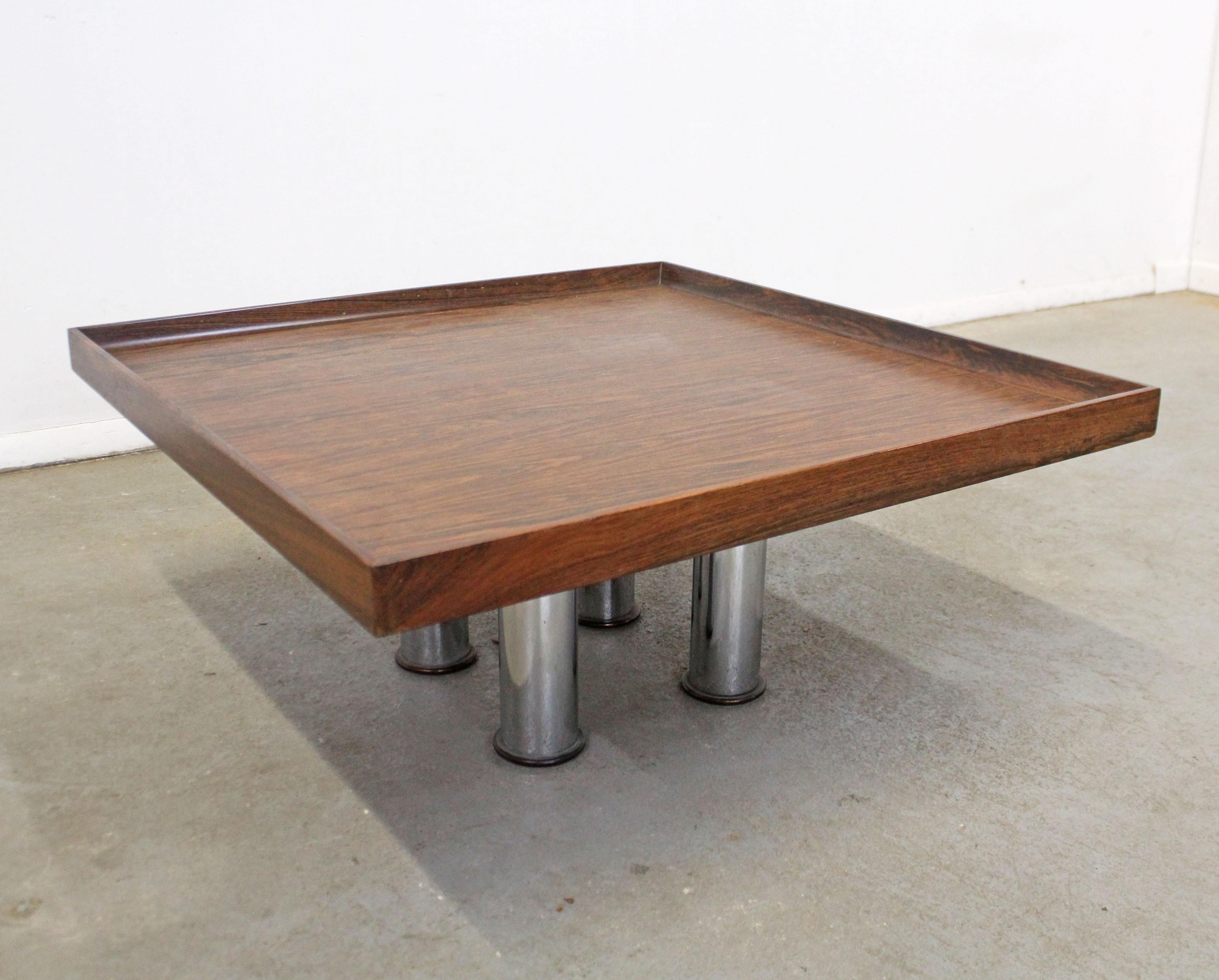Offered is a Mid-Century Modern rosewood coffee/end table attributed to Knoll. Features a square top and four chrome legs. In good condition, shows some slight wear (patina on chrome, minor surface wear-see photos). It is unsigned. A great piece to