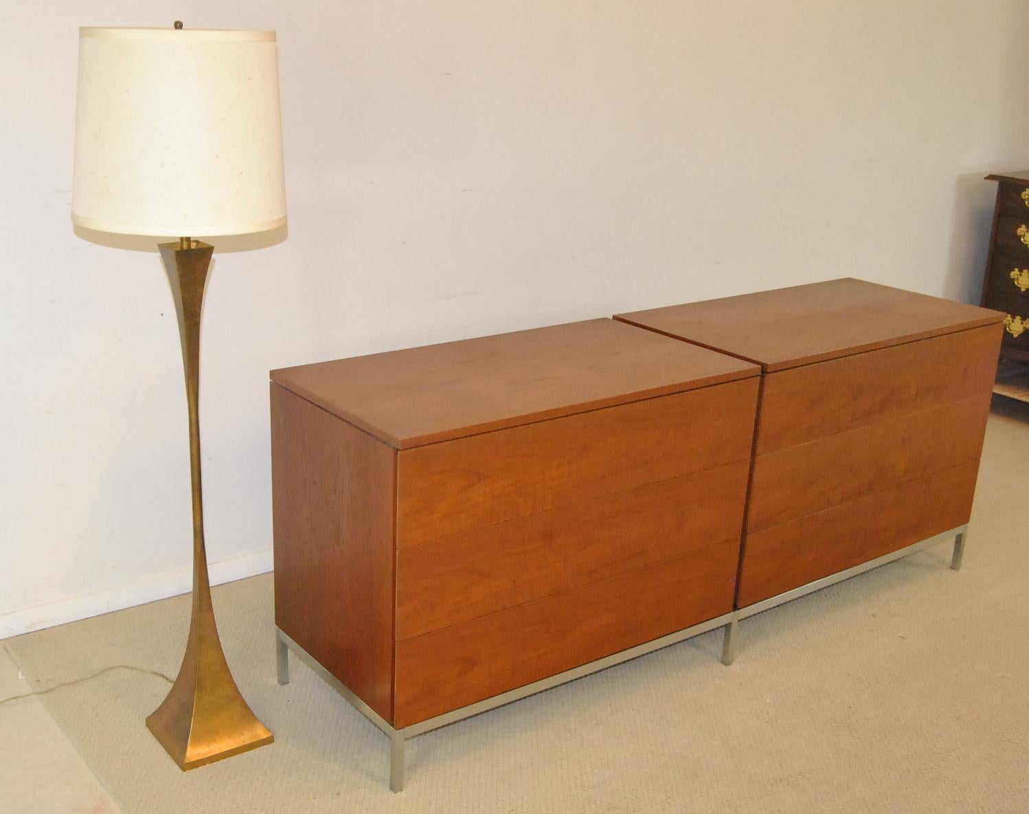 Mid-Century Modern walnut pair three drawer chests on a single aluminum base.