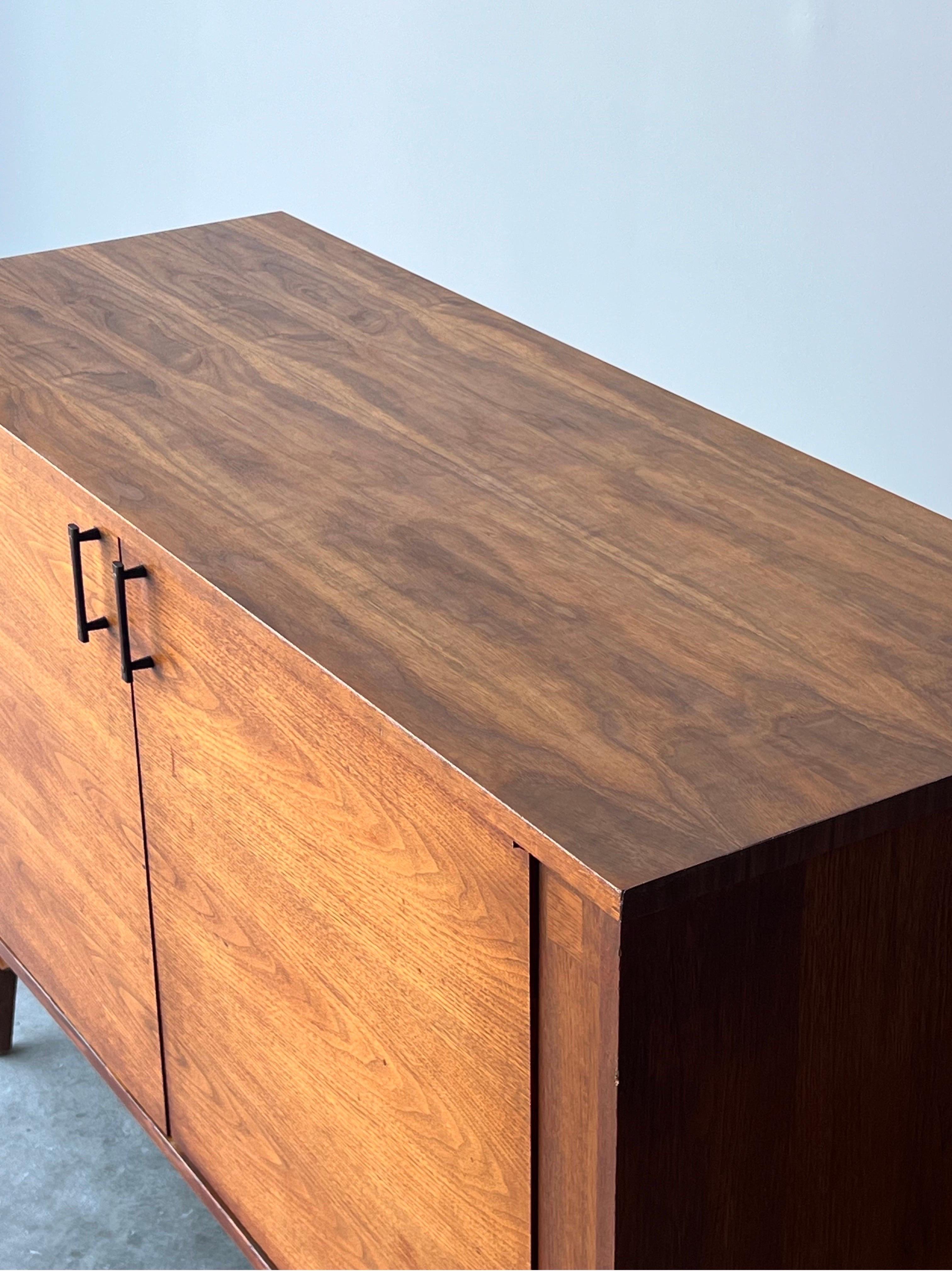 If you’re looking for a credenza rich in details then look no further. Mid-century walnut credenza with rosewood accents. Made by Kroehler circa 1960’s. This sideboard is the perfect media console or dining room item. Nice rosewood handles and