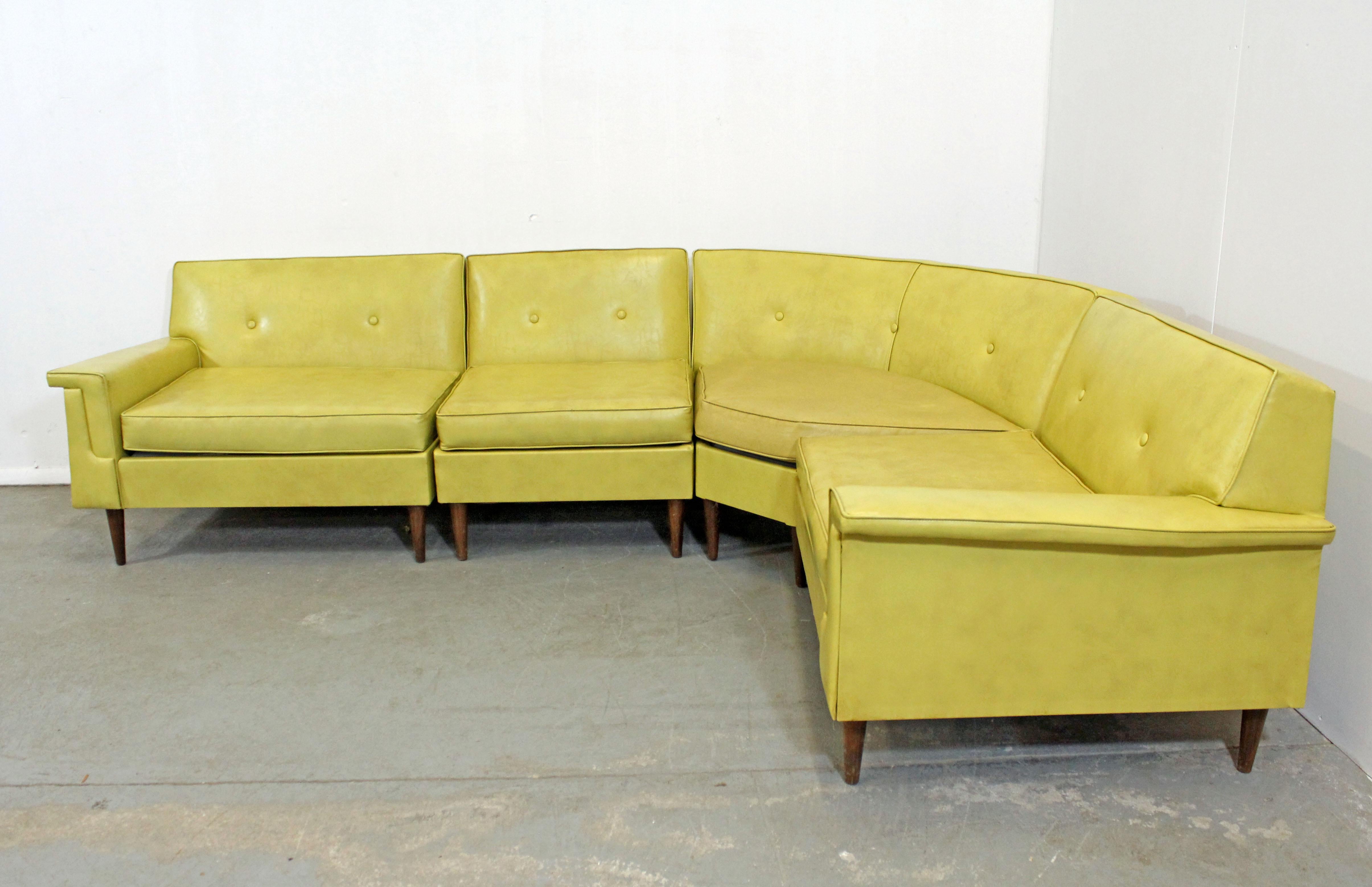 Offered is a Mid-Century Modern four-piece sectional sofa by Kroehler. This sofa has a super cool retro, modular style with vinyl upholstery. It is in structurally sound condition, but needs to be reupholstered. The vinyl upholstery has stains and