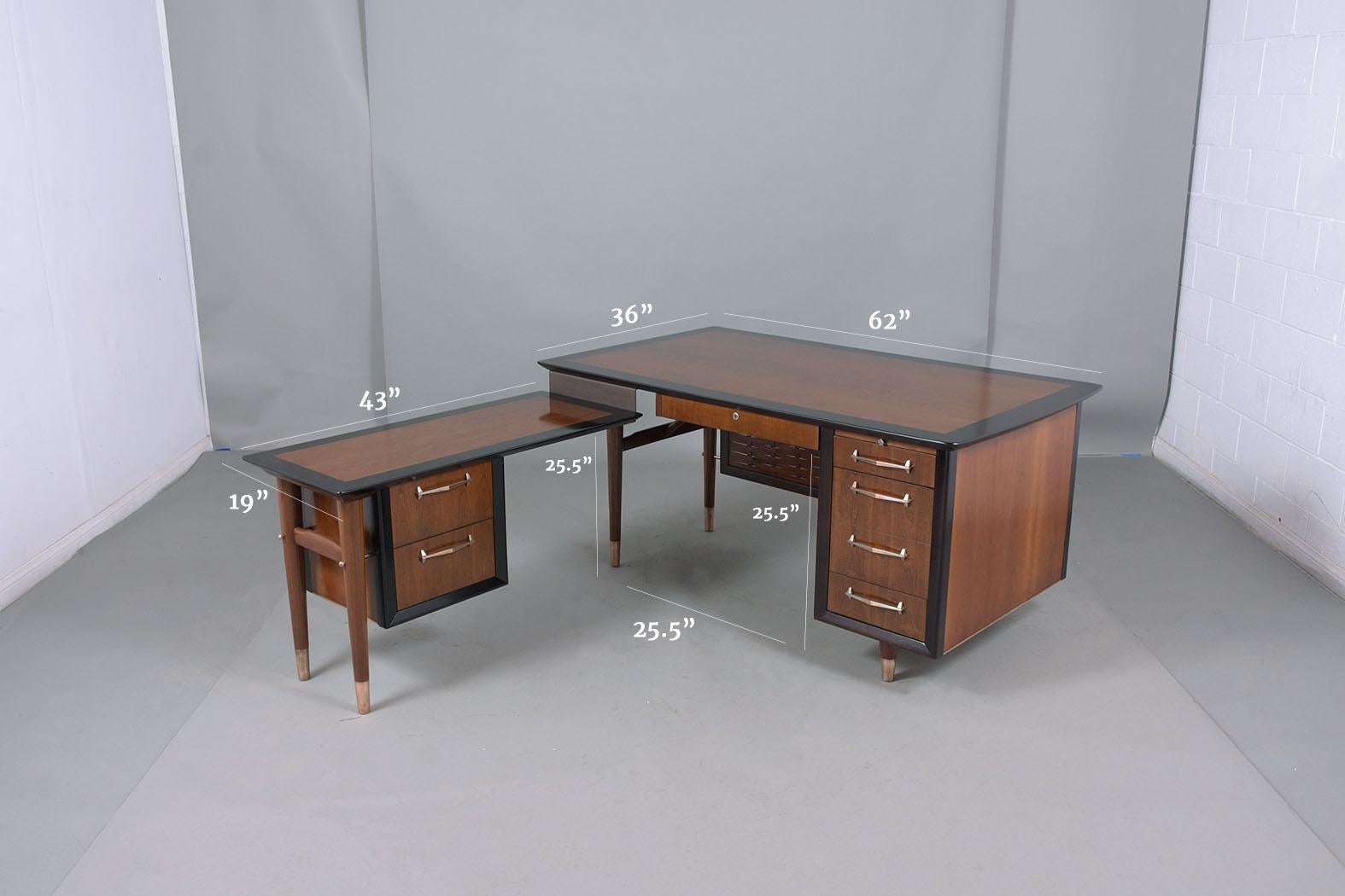 An extraordinary Mid-Century Modern 1960s desk crafted out of walnut wood professionally restored and finished by our craftsmen in the house. This piece has been newly stained in a provincial and ebonized color with a newly lacquered finish and