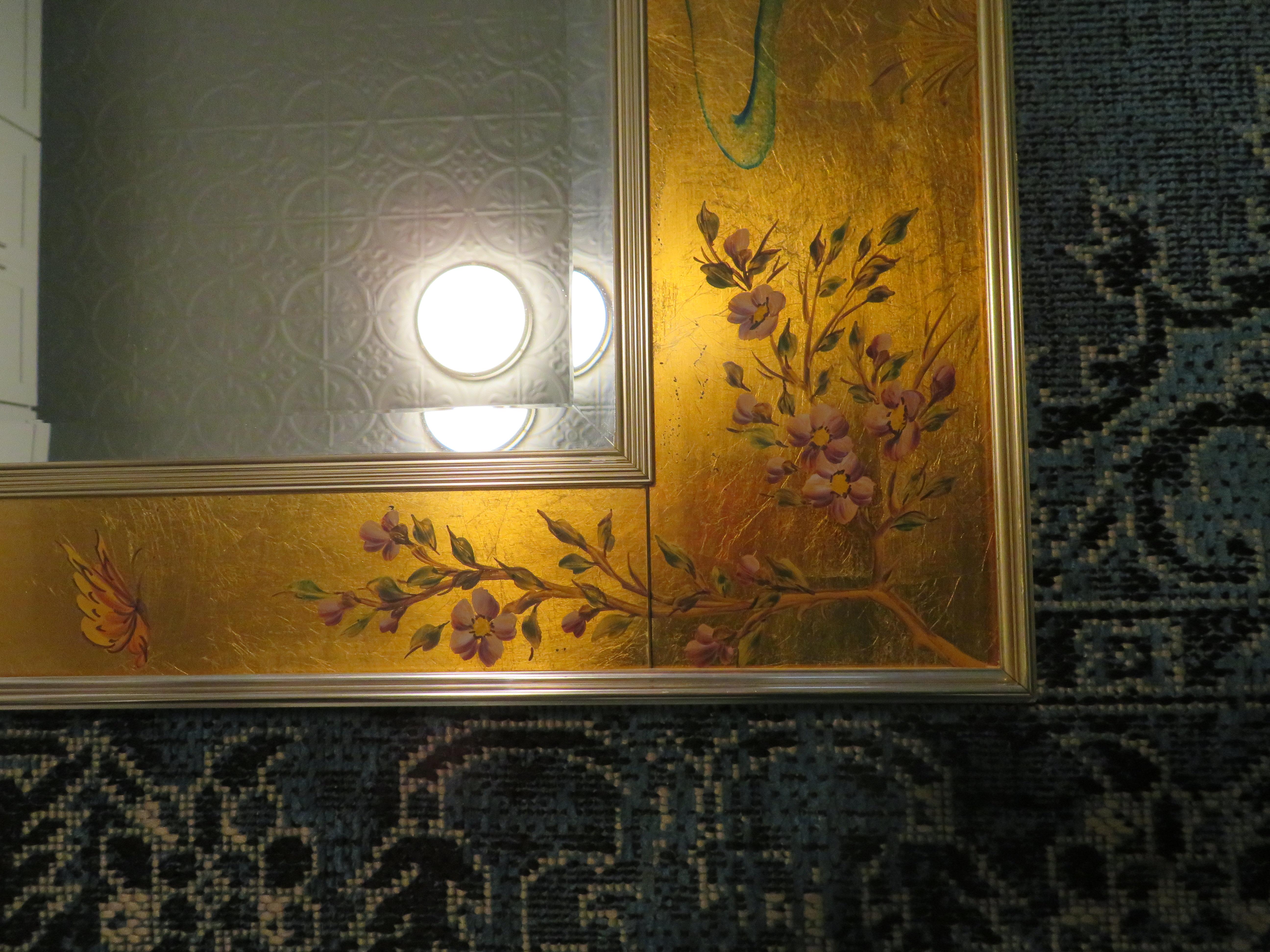 Stunning Labarge églomisé beveled mirror with reverse painted Asian scenery on a gold background; hallmarks on back.