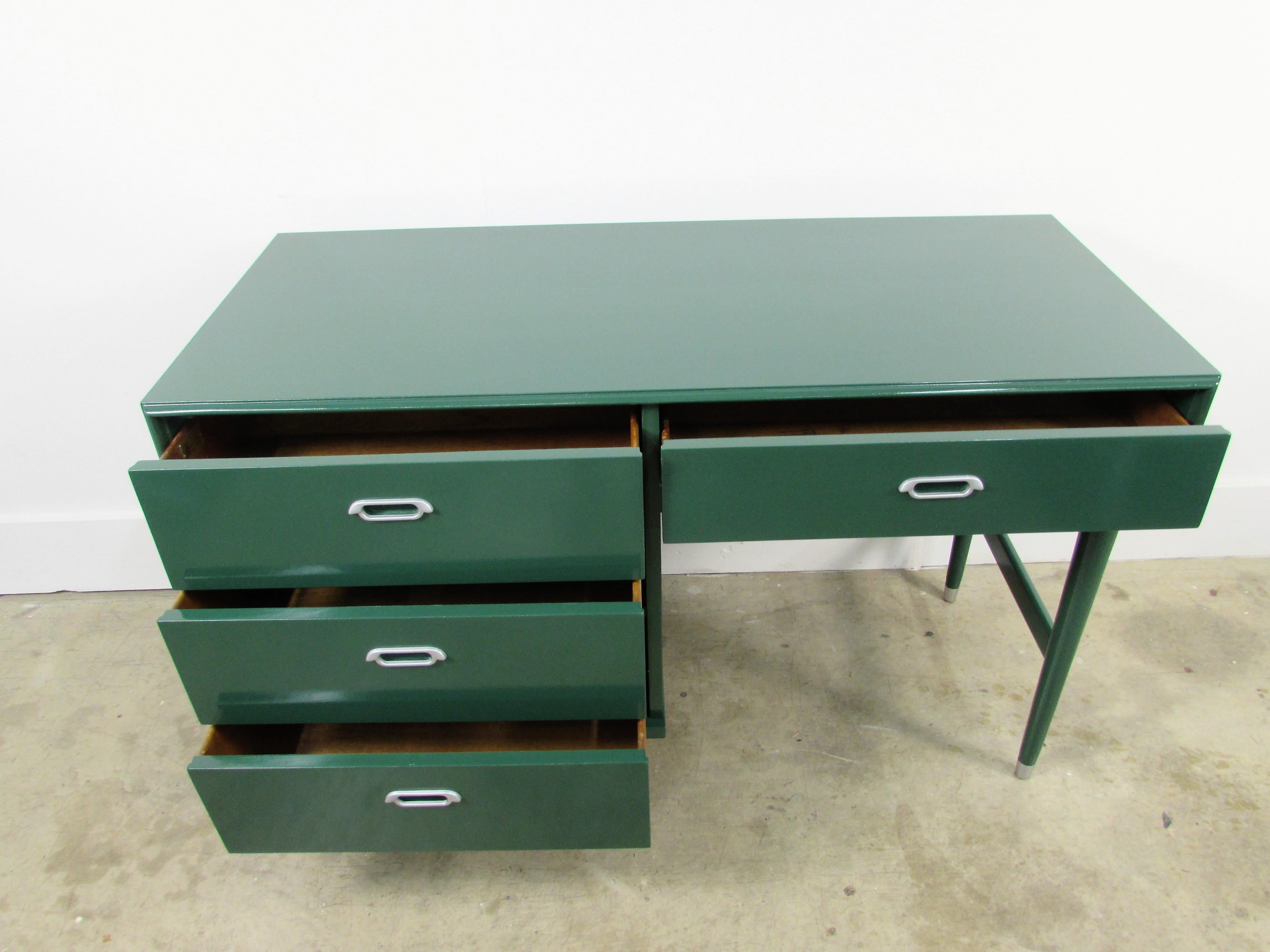 Mid-Century Modern lacquered desk customized In-house in Benjamin Moore HC-189 chrome green with silver hardware ending in cap feet with four dove tail drawers, desk can float in a room.