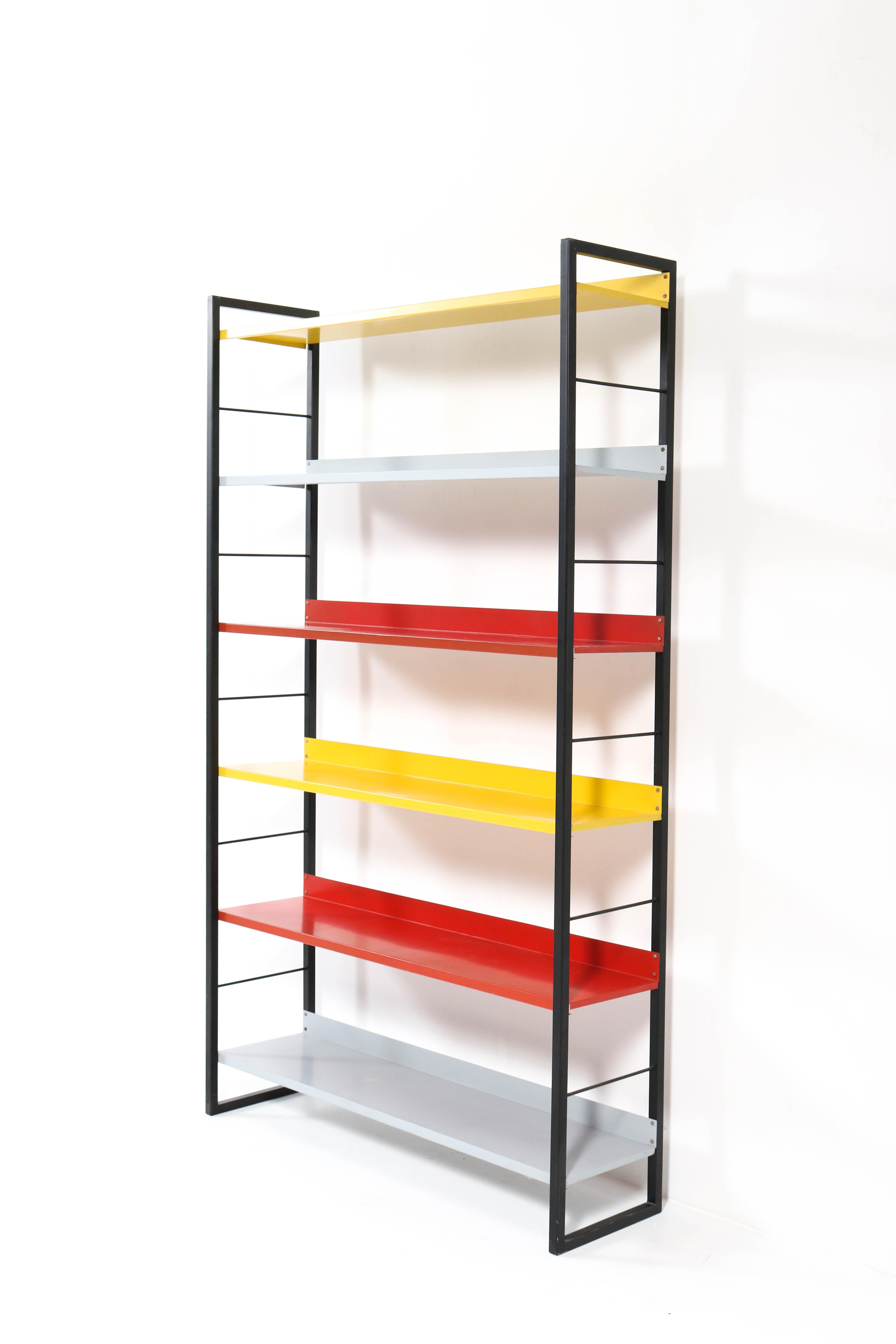 Stunning Mid-Century Modern bookcase.
Design by Adriaan Dekker for Tomado.
Striking Dutch design from the 1950s.
Black lacquered metal frame with yellow, red and grey lacquered metal shelves.
In very good condition with minor wear consistent