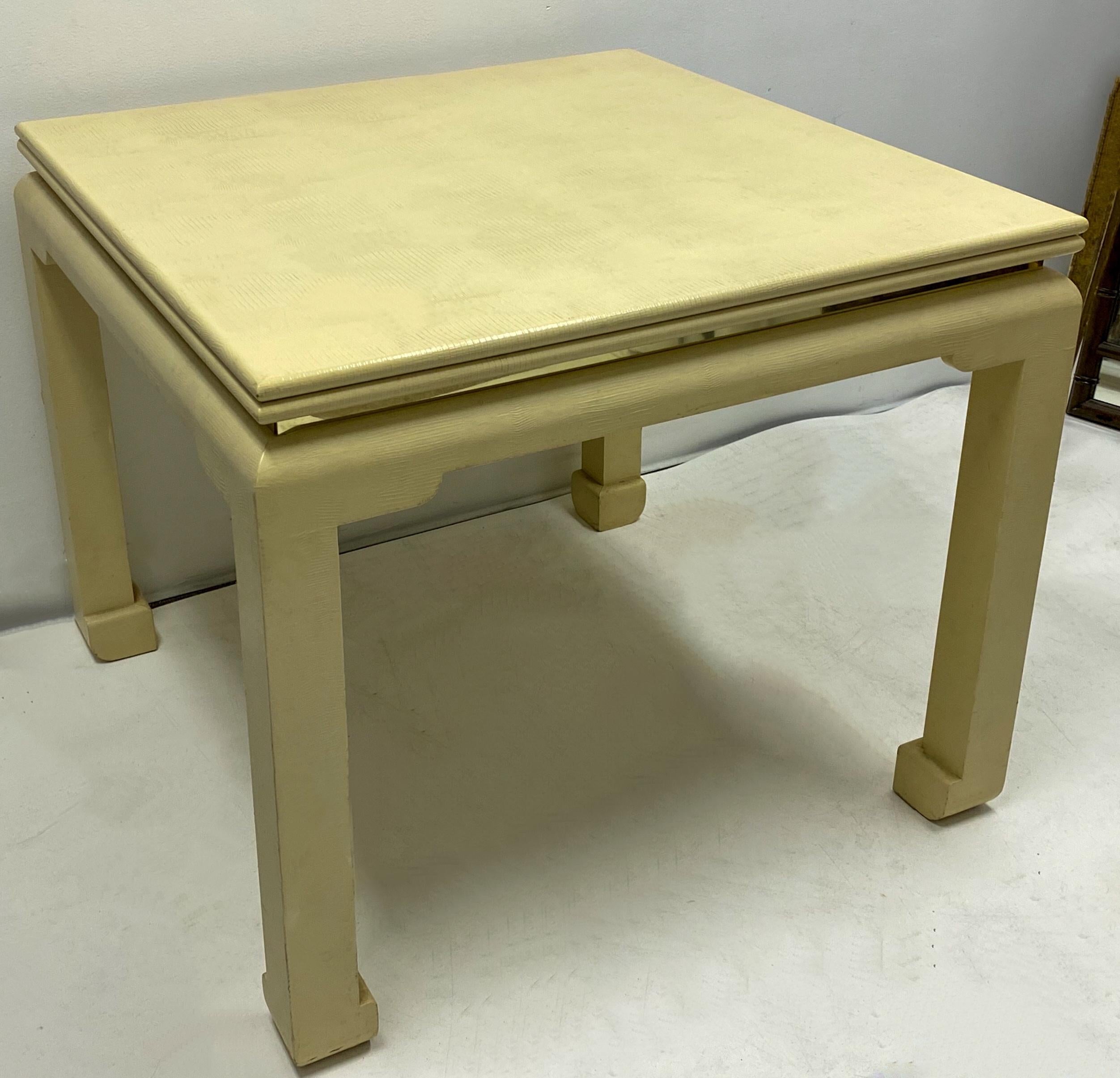 This is a Mid-Century Modern lacquered goatskin wrapped game table that converts to a dining table and is attributed to designer Karl Springer. The table also has a brass band that wraps around the entire piece. It is in the original color and very