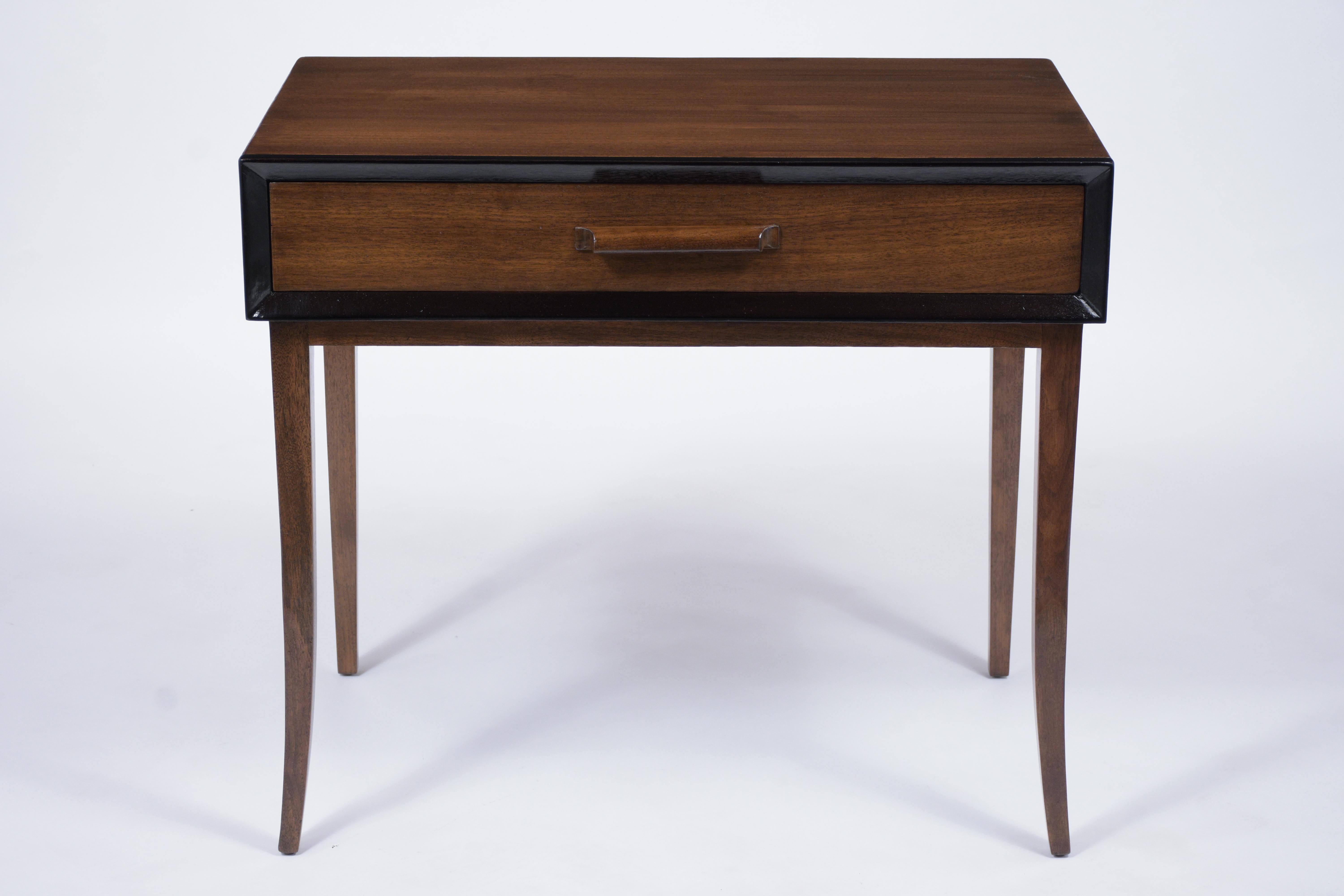 This Mid-Century Modern Desk crafted out of walnut has been completely restored and features walnut and black color combinations with a newly lacquered finish. The vanity table has ebonized details on the molding, comes with a large drawer with a
