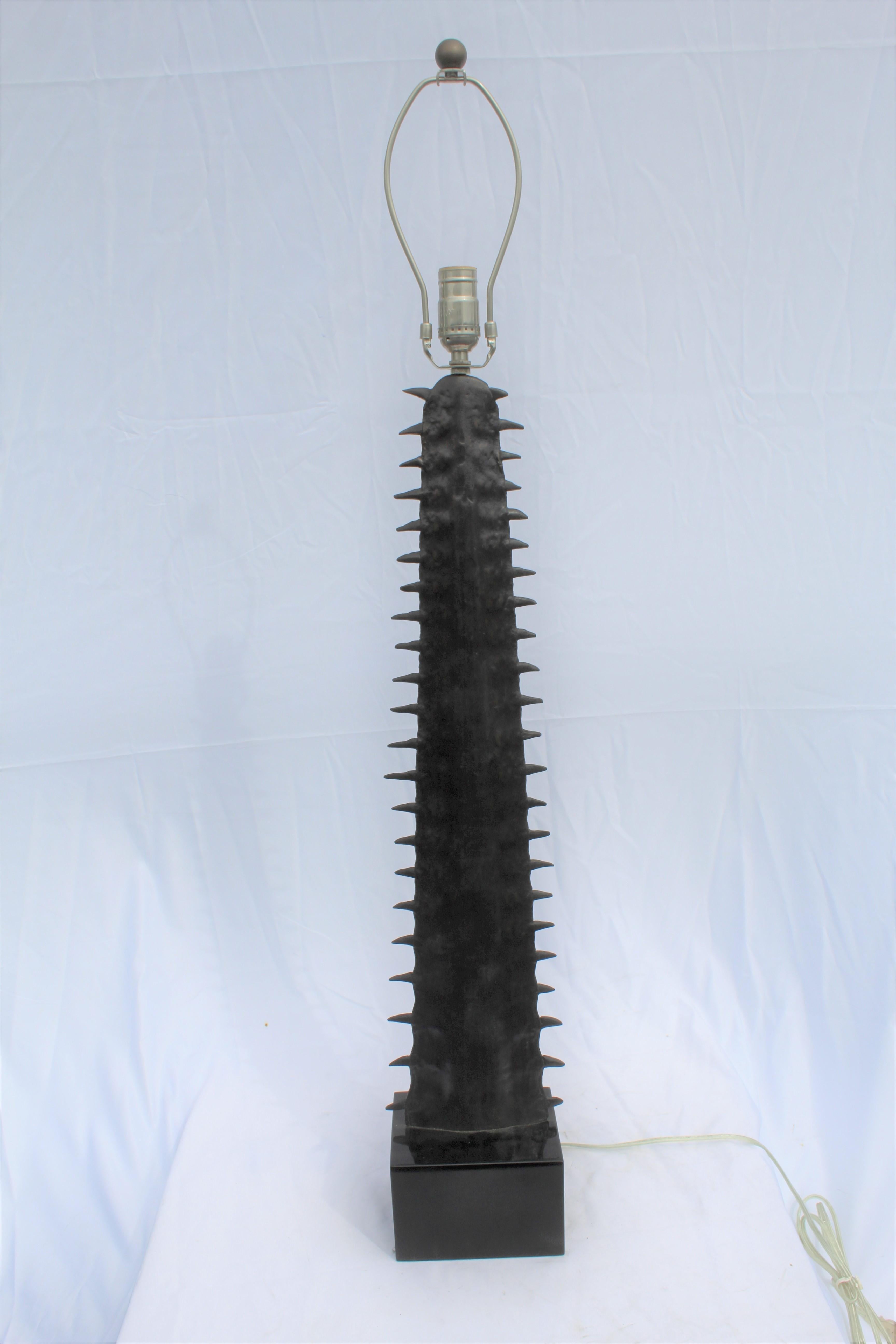 A unique lamp contemporary bronze castling from an original Saw Tooth Shark nose bill . Finished in a dark bronze patina and mounted on a solid black marble base . Has a single Edison socket and a harp . Total ht with the base is at 40 