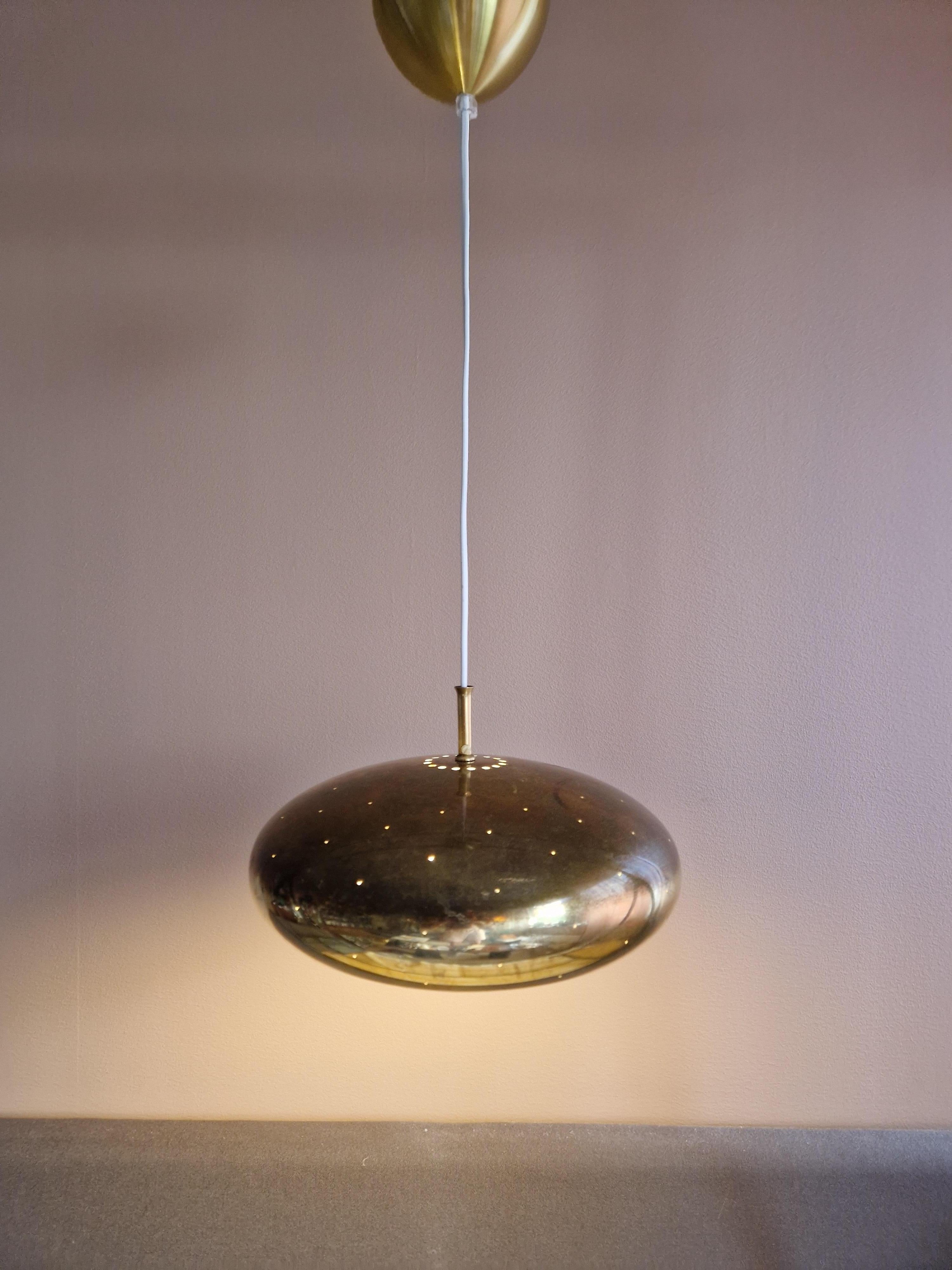A rare ceiling pendant from Falkenberg Belysning. Made in solid brass in the 1960´s. This model is more unusual than most of these lamps because of the small perforated holes throughout the shade. This makes the light trickle through everywhere on