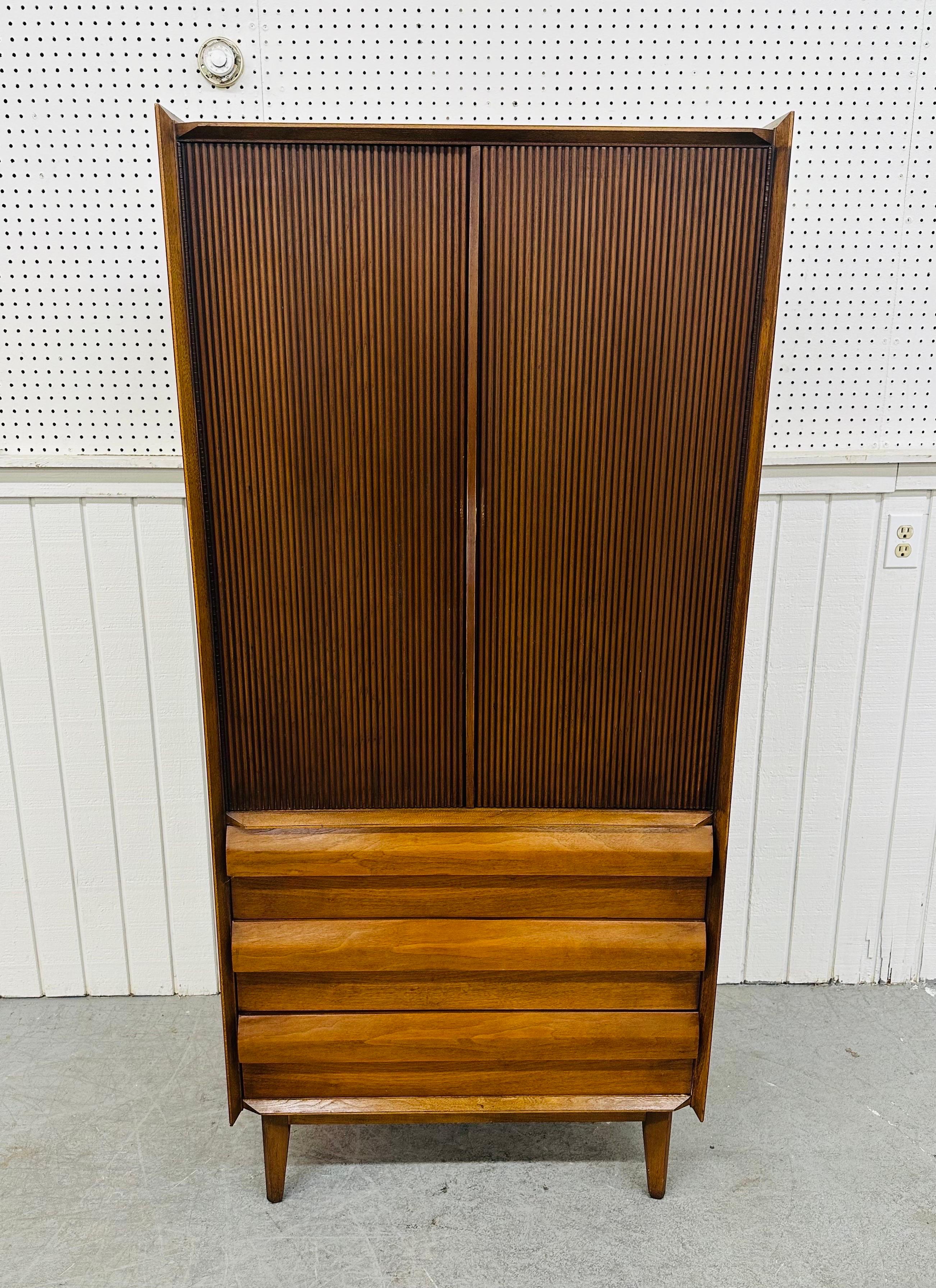 This listing is for a Mid-Century Modern Lane “1st Edition” Walnut Armoire. Featuring a straight line design, two large reeded style doors that open up to storage space, the interior doors have a mirror on the left side and tie organizer on the
