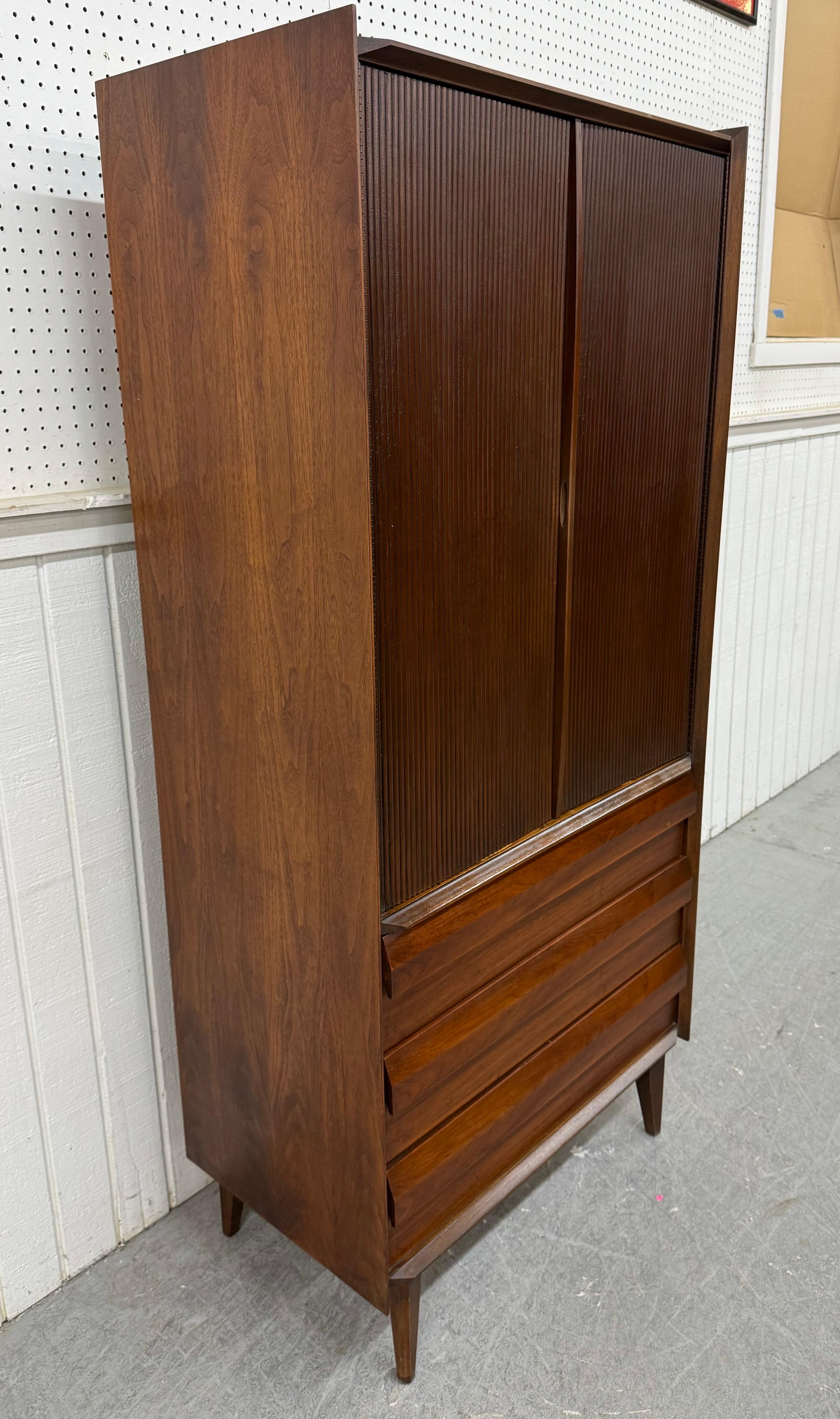 This listing is for a Mid-Century Modern Lane 1st Edition Walnut Armoire. Featuring a straight line design, two large doors that open up to storage space, hidden mirror and jewelry hooks, three large drawers at the bottom, modern legs, and a