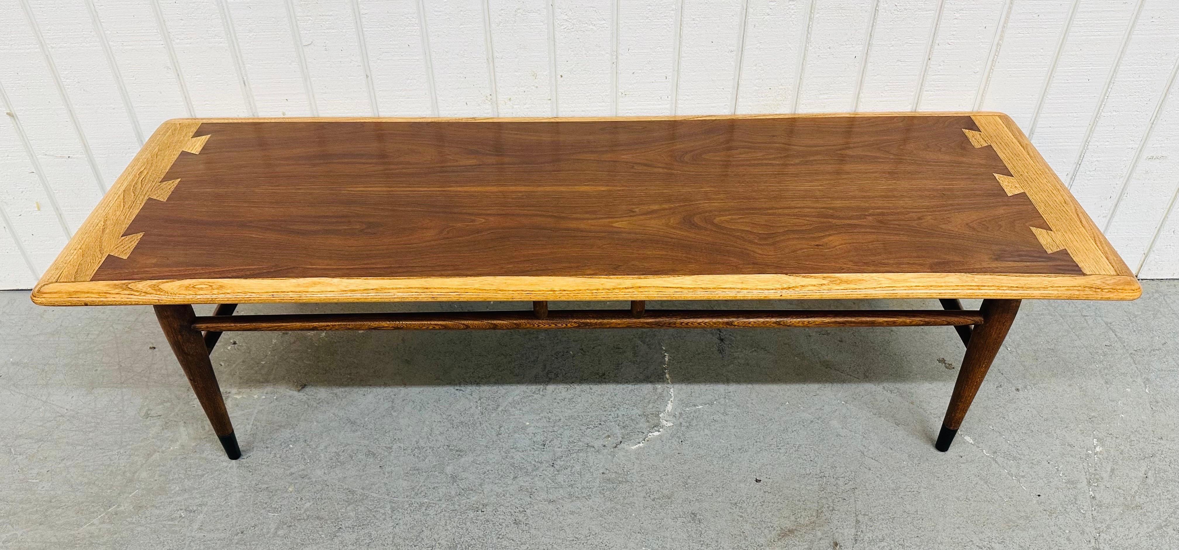 This listing is for a Mid-Century Modern Lane Acclaim Walnut Coffee Table. Featuring a rectangular two-tone dove tailed top, four legs with a stretcher base, and a beautiful walnut finish. This is an exceptional combination of quality and design by