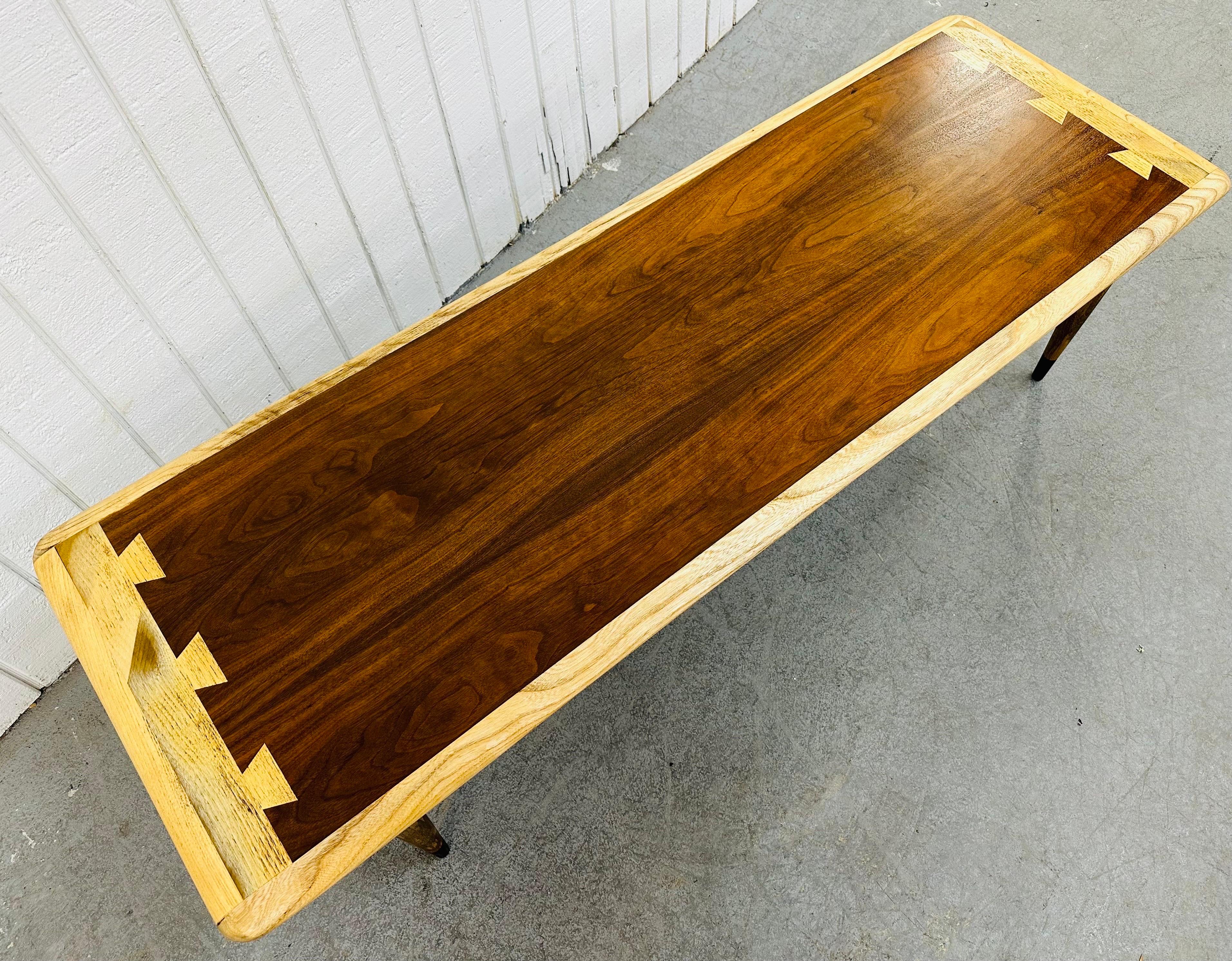 This listing is for a Mid-Century Modern Lane Acclaimed Walnut Coffee Table. Featuring a rectangular top, four modern legs with stretchers, black painted tips, and a beautiful two toned dovetailed top! This is an exceptional combination of quality
