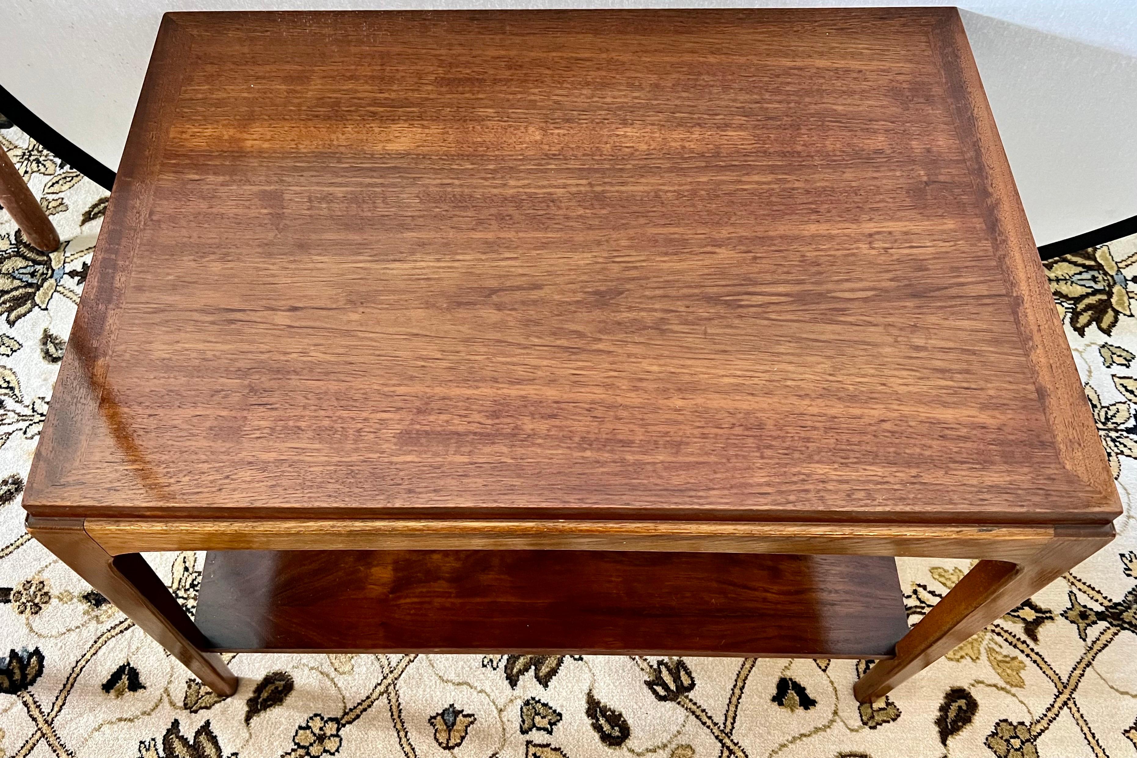 Mid century high quality two-tiered walnut side table by Lane Furniture's Altavista line. It’s simple clean lines will fit any mid century design aesthetic. Hallmarked on bottom. Great lines and better scale.