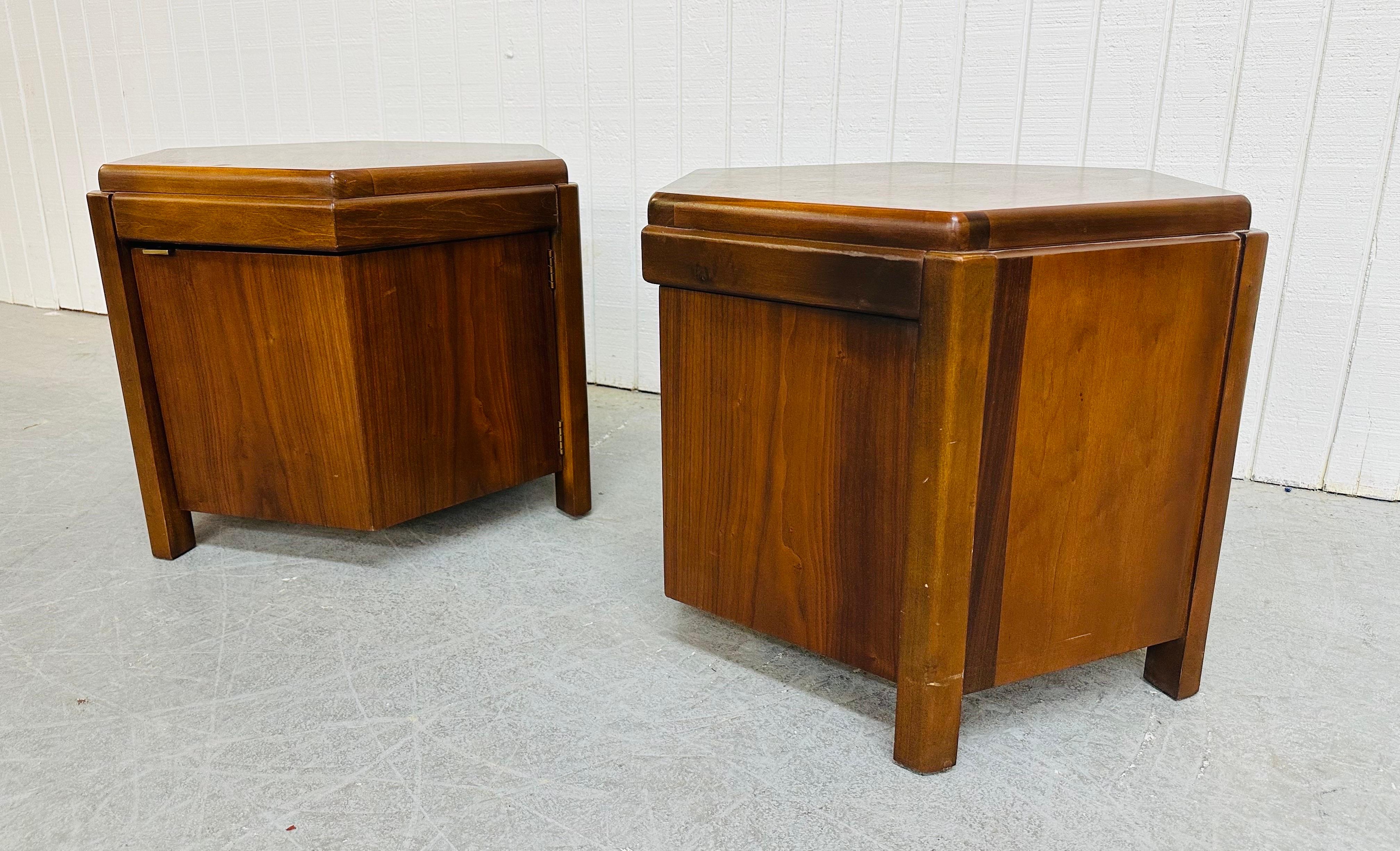 This listing is for a pair of Mid-Century Modern Lane Hexagonal Walnut Side Tables. Featuring a hexagonal design, single door that opens up to storage space, and a beautiful walnut finish. This is an exceptional combination of quality and design by