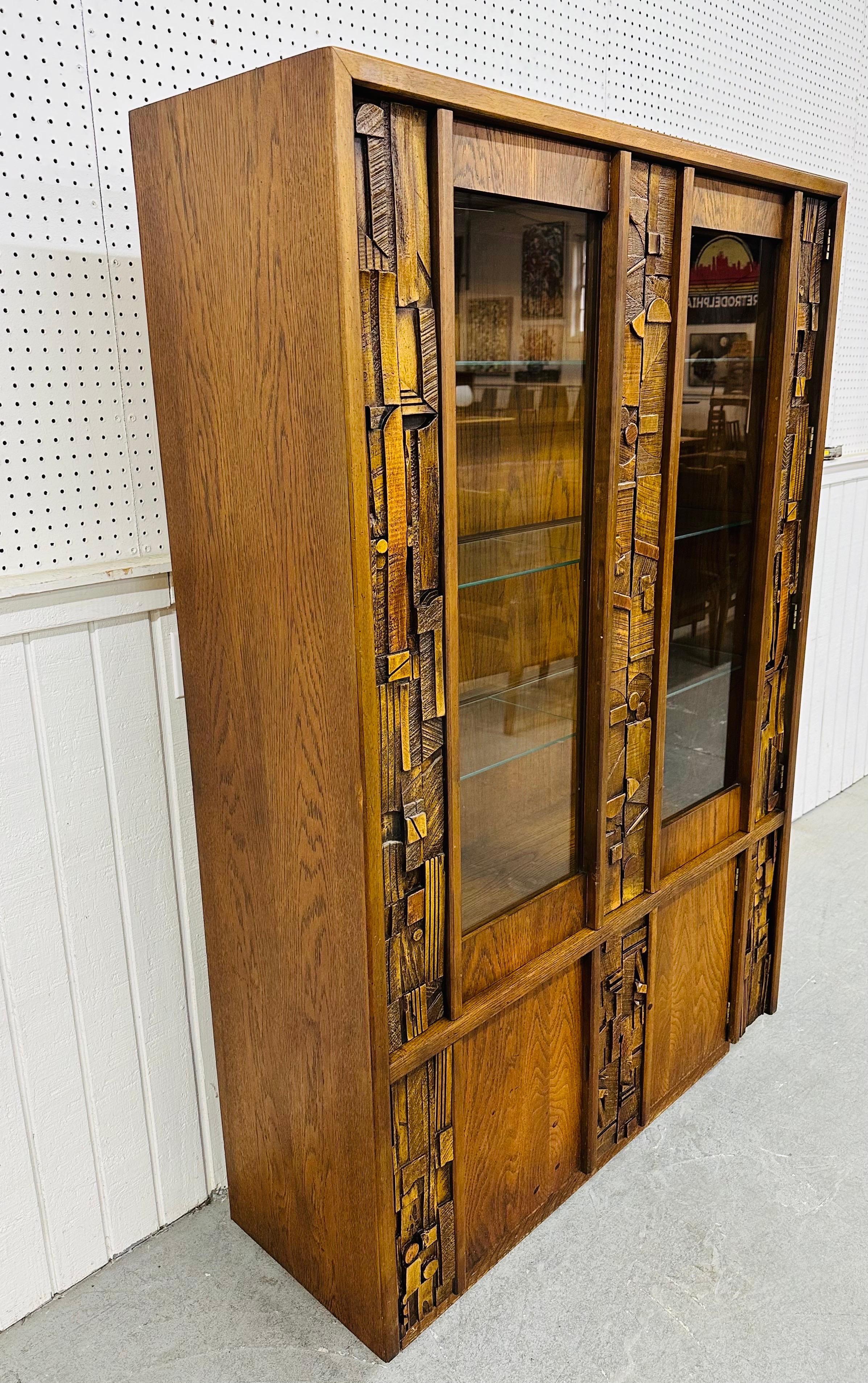 This listing is for a Mid-Century Modern Lane Pueblo Brutalist Display Cabinet. Featuring a straight line brutalist design, two doors that open up to three glass shelves, interior light, two doors at the bottom that open up to storage space, and a