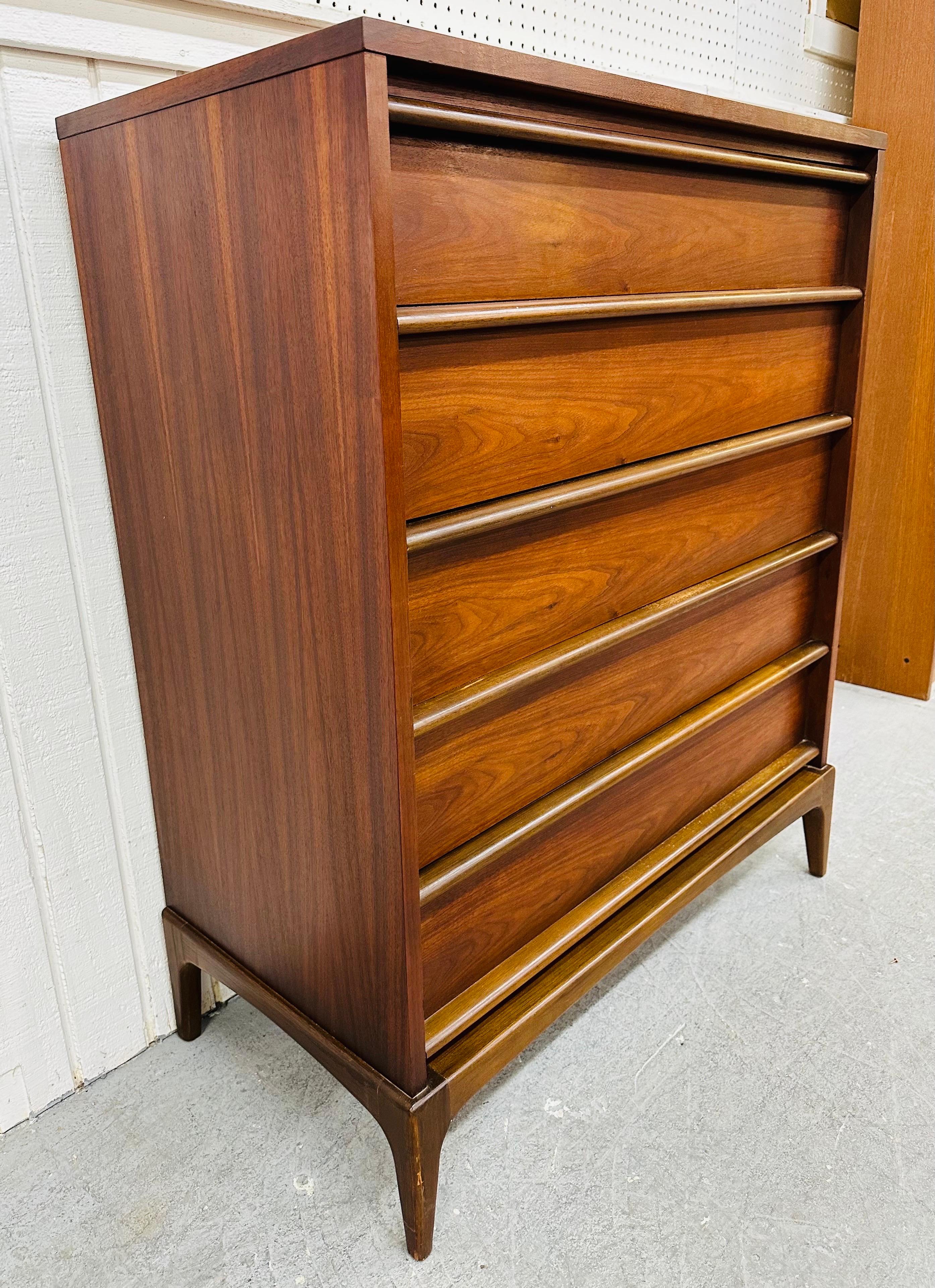 This listing is for a Mid-Century Modern Lane Rhythm Walnut High Chest. Featuring a straight line design, five drawers with wooden pulls, modern legs, and a beautiful walnut finish! This is an exceptional combination of quality and design!