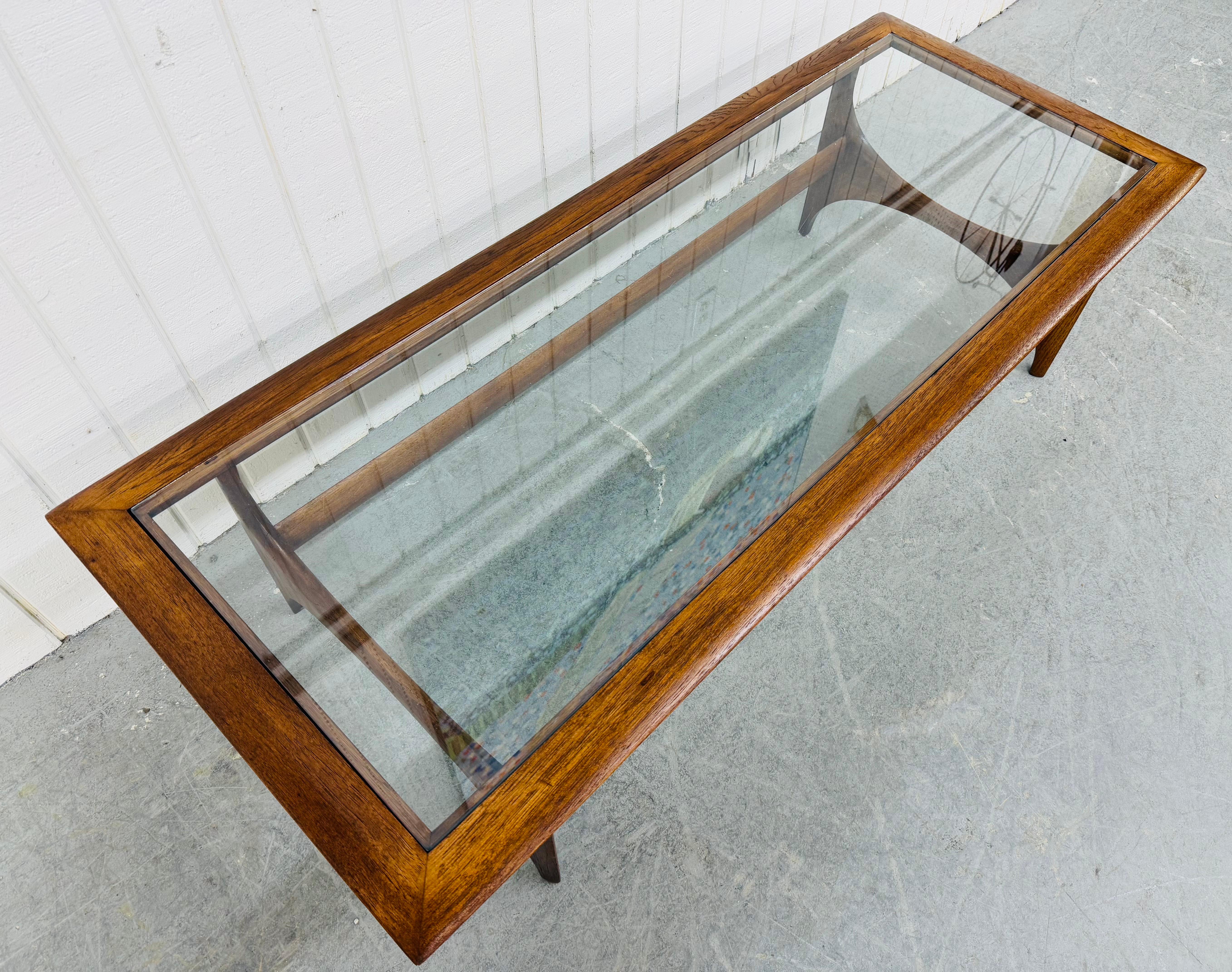 This listing is for a Mid-Century Modern Lane Silhouette Glass Top Walnut Coffee Table. Featuring a rectangular glass insert top, walnut frame, sculpted legs with stretcher base, and a beautiful walnut finish. This is an exceptional combination of