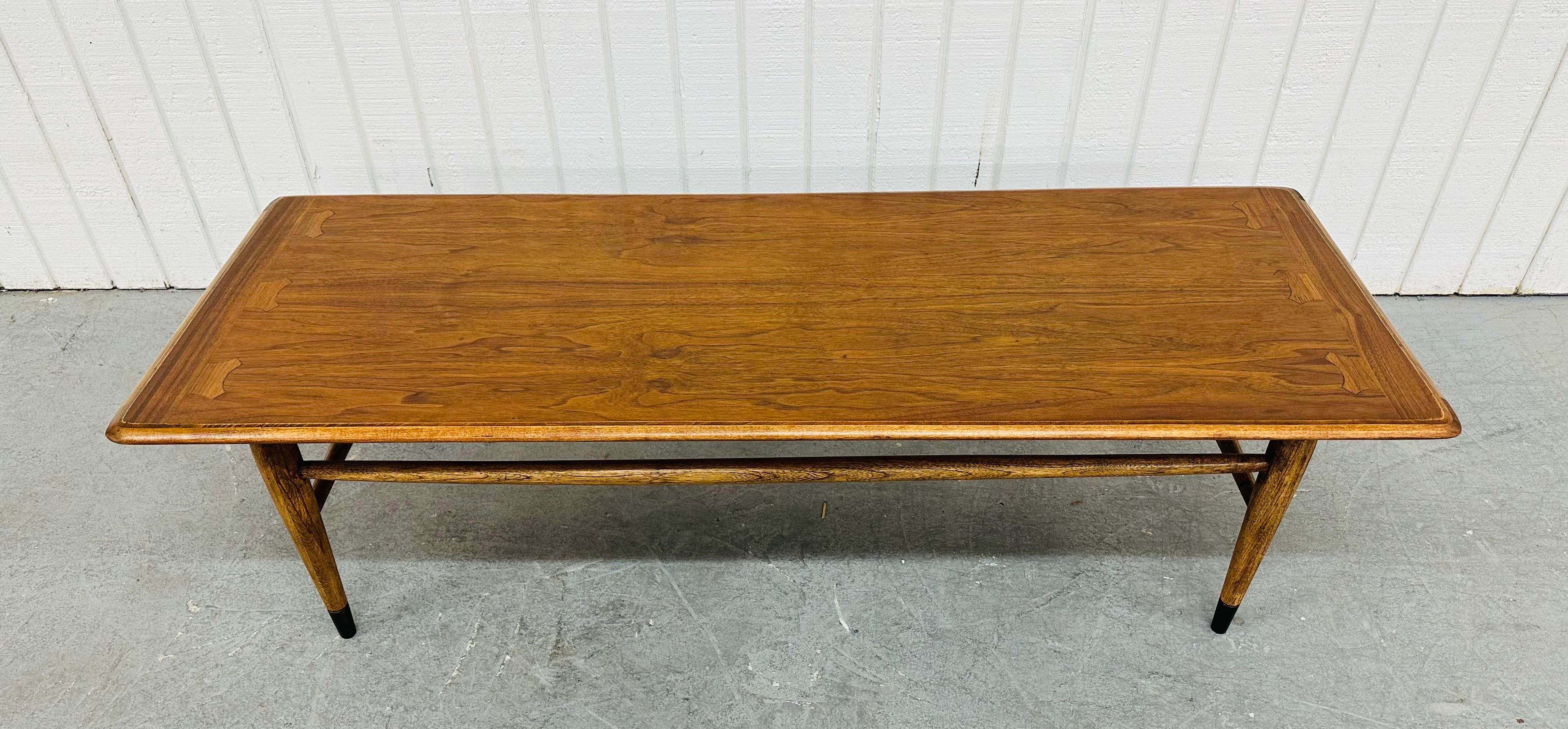 This listing is for a Mid-Century Modern Lane Style Walnut Coffee Table. Featuring a straight line design, rectangular top, modern legs with stretchers, and a beautiful walnut finish. This is an exceptional combination of quality and design in the